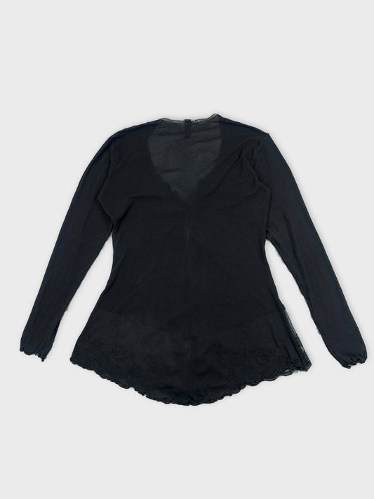 Back view of a black long-sleeve top with a scalloped hem.