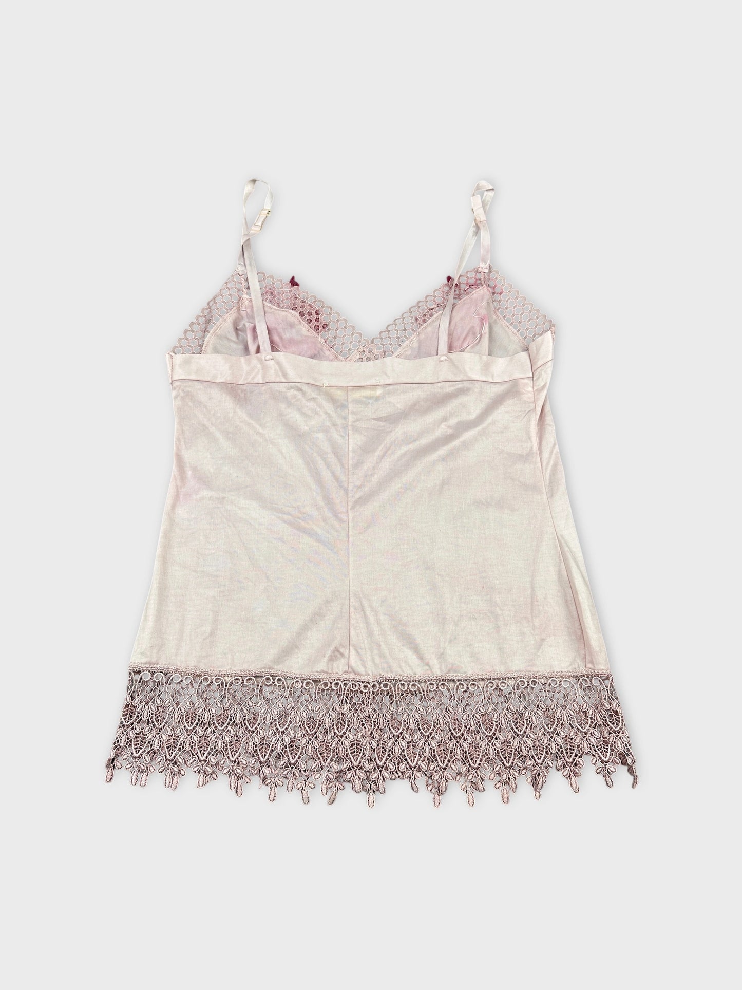 Back view of a pink vintage top featuring lace trim at the hem.