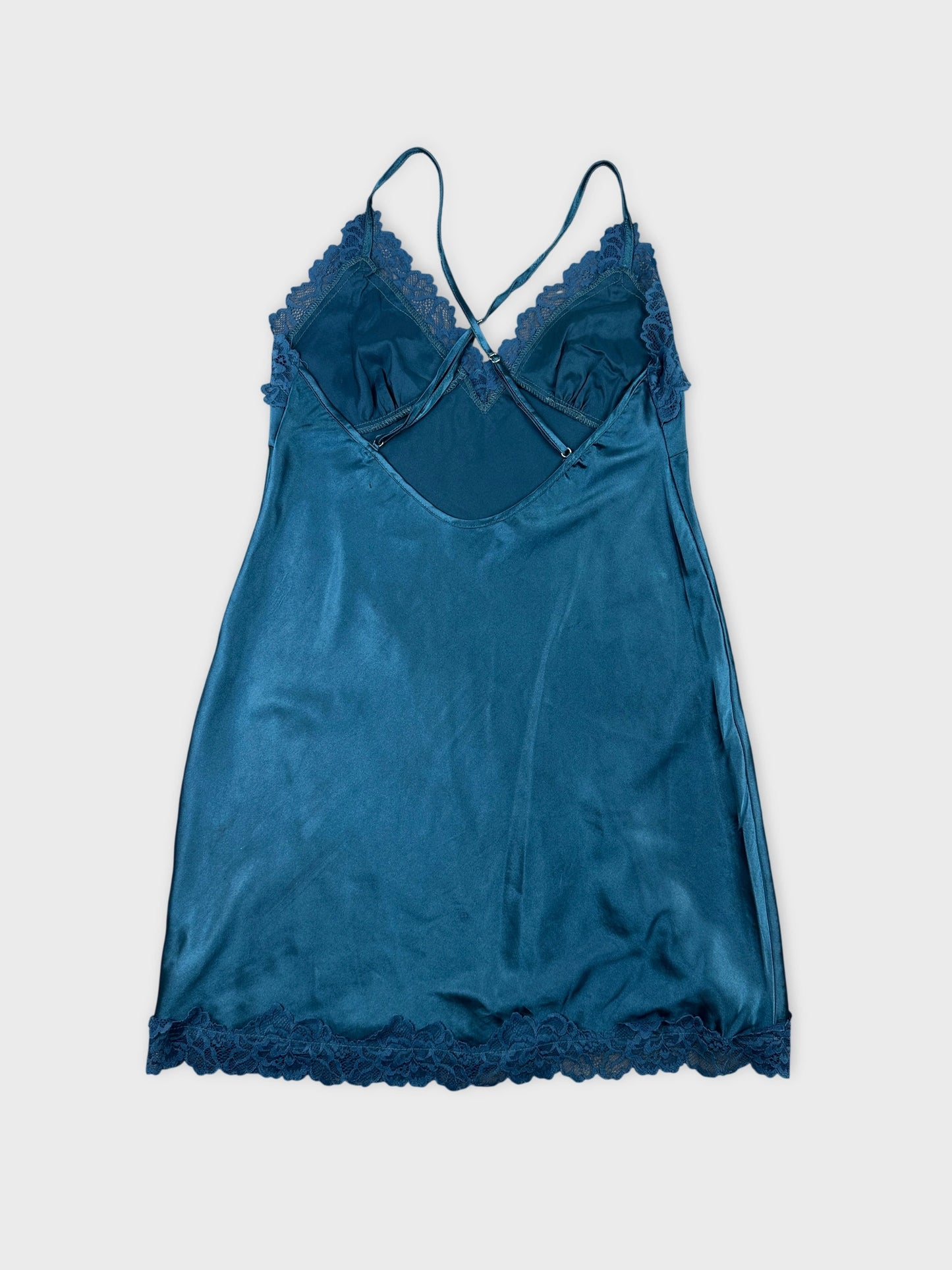 Back view of a teal camisole with lace trim.
