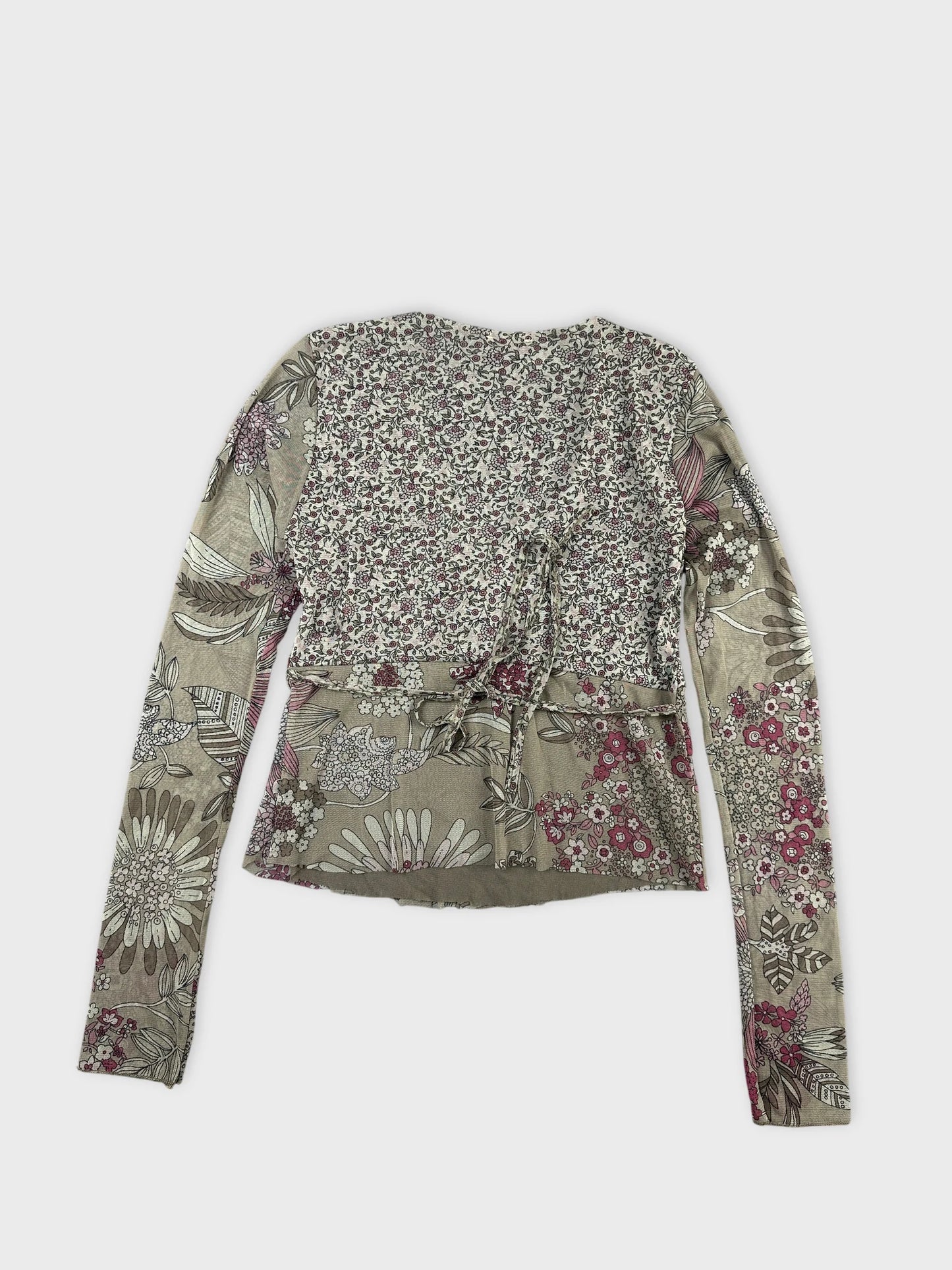 Back view of a vintage floral top in muted earth tones featuring long sleeves.