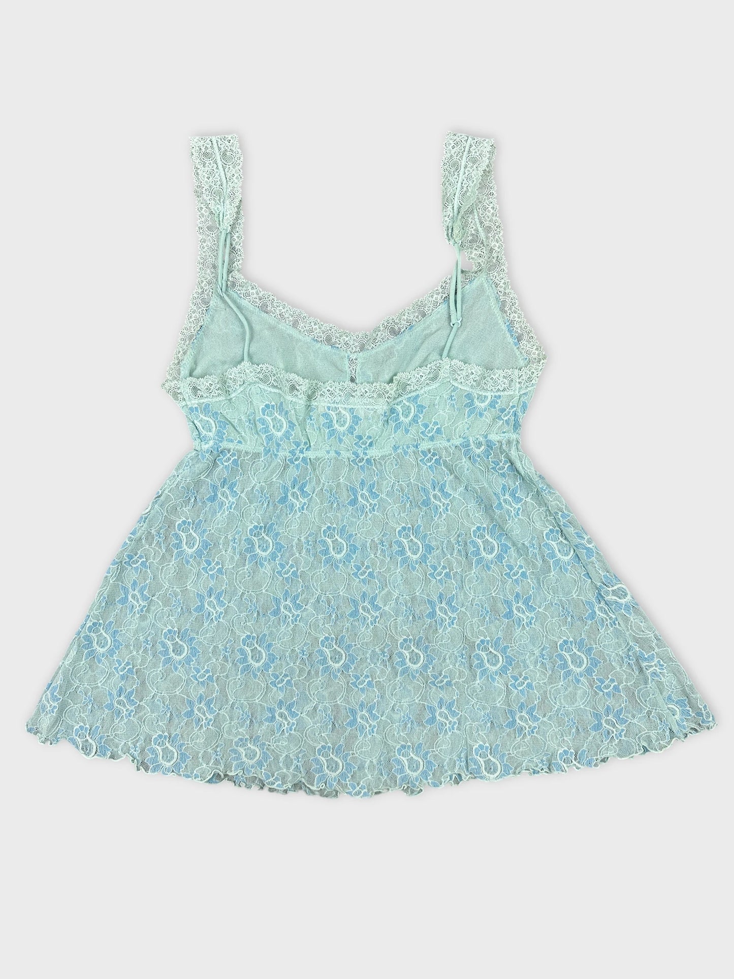 Back view of a mint green lace top with adjustable straps.