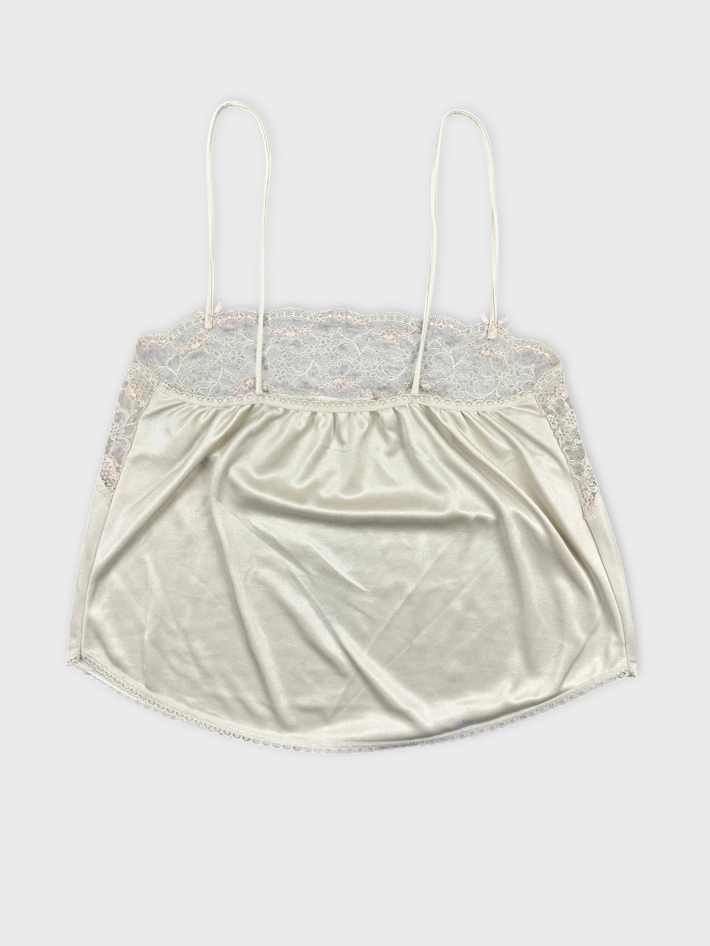 Back view of a cream lace-trimmed camisole top.