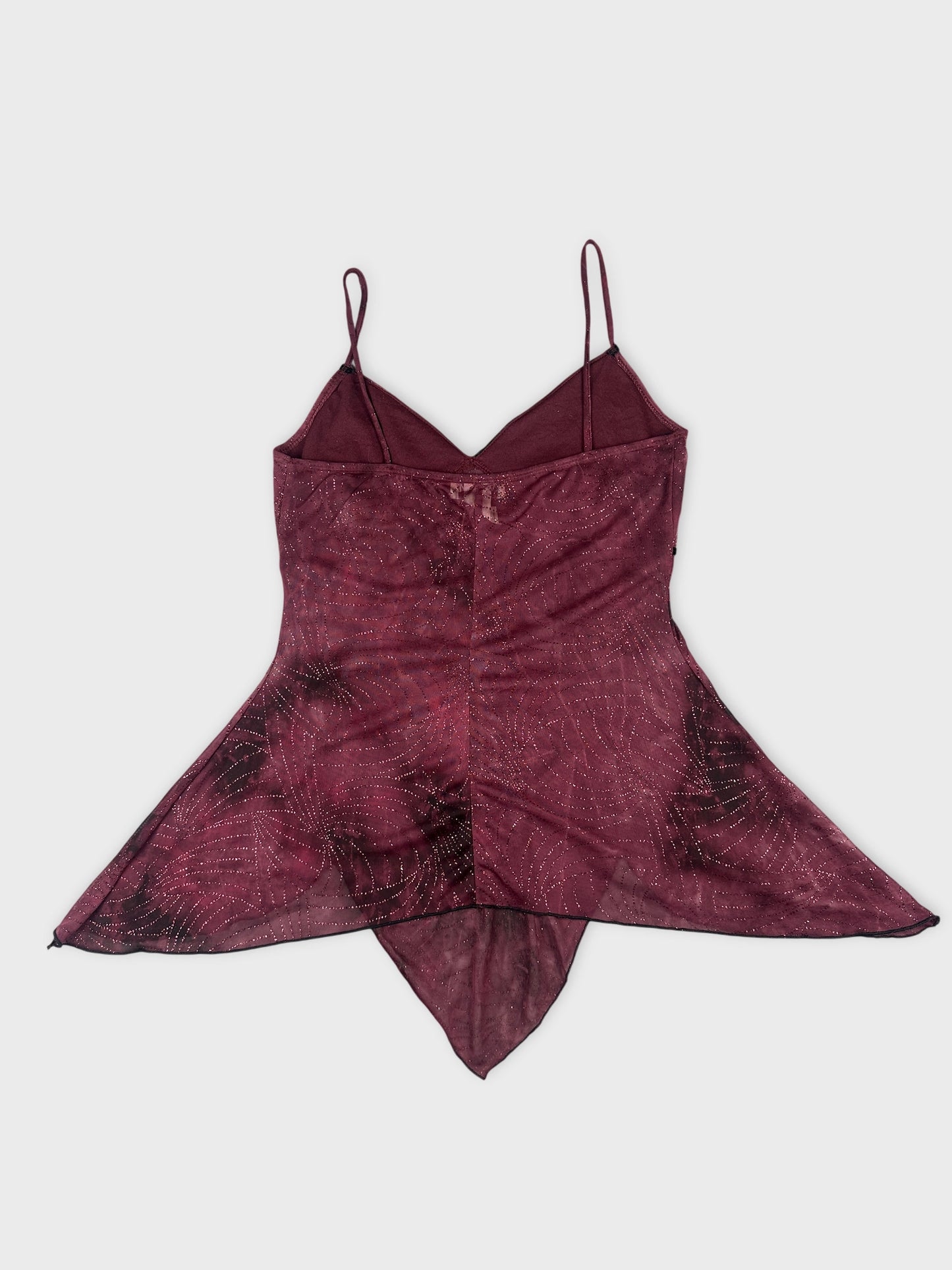 Back view of a burgundy top with a flowing shape and intricate pattern.