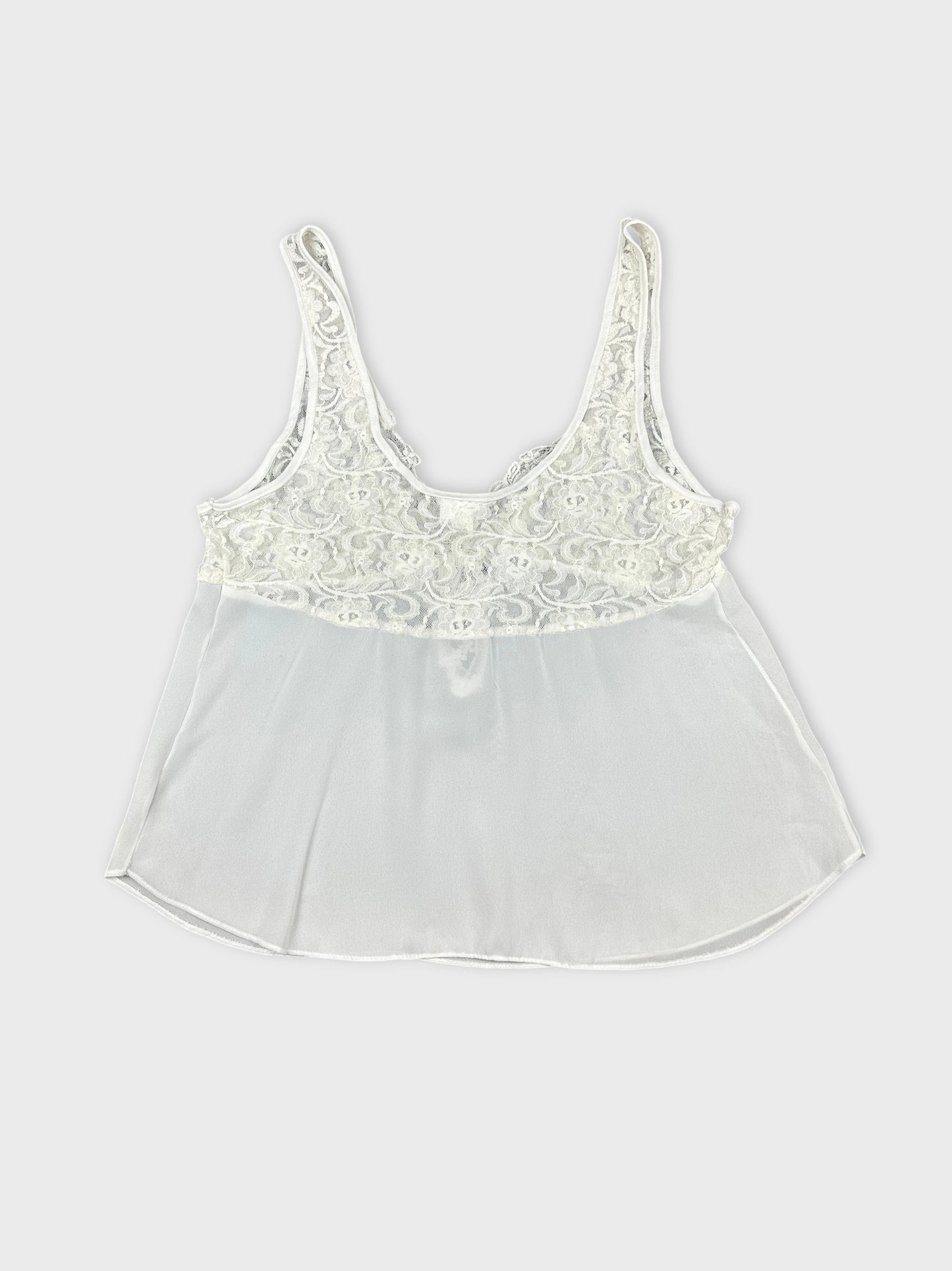 Back view of white vintage top featuring lace detailing and a flowy silhouette.