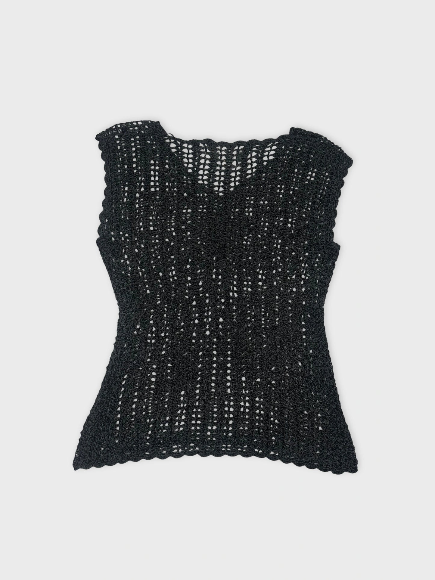 Back view of a black knitted top featuring a scalloped hem.
