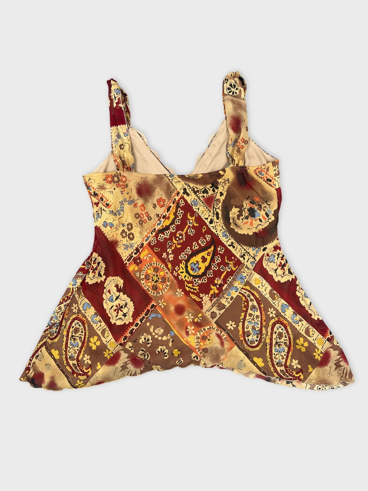 Back view of a patchwork top in burgundy with floral patterns.