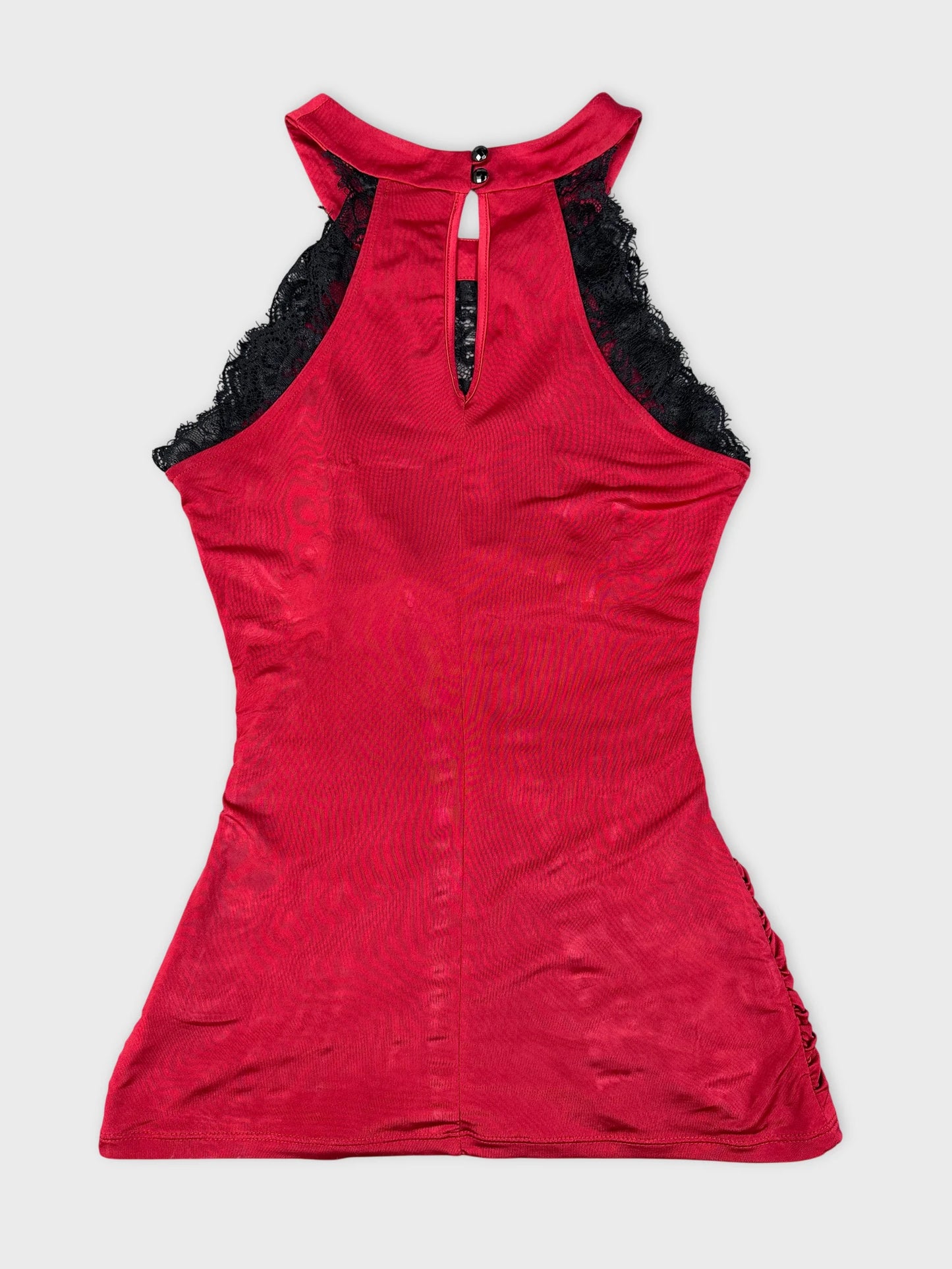 Back view of a red sleeveless top with black lace detail.