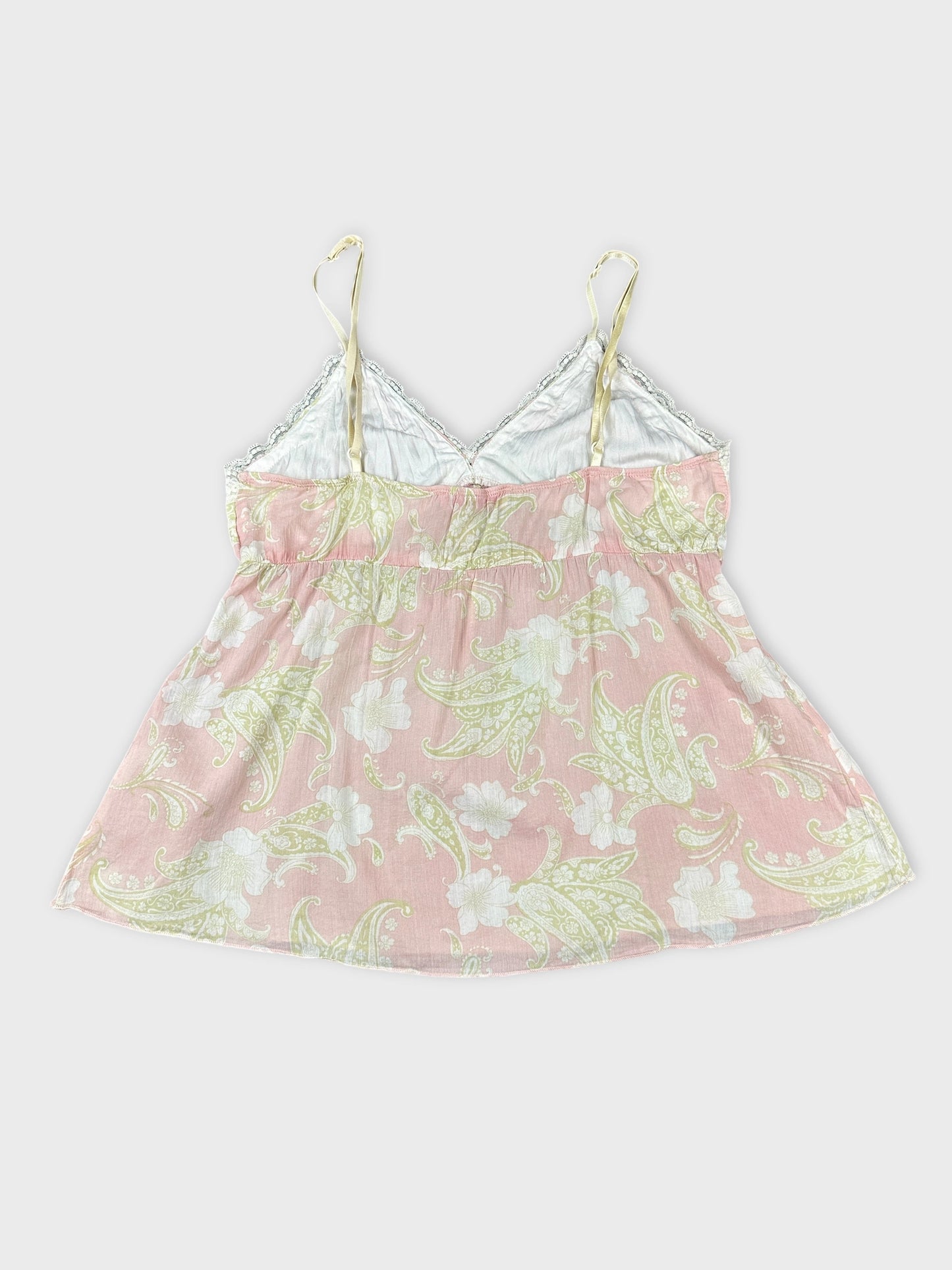 Back view of a pink floral patterned women's top with spaghetti straps.