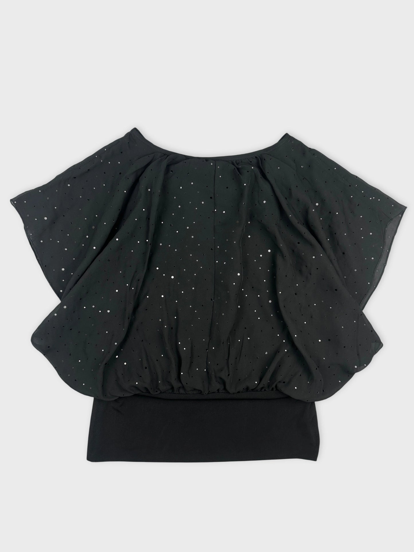 Back view of a black vintage top featuring a shimmery dot pattern.