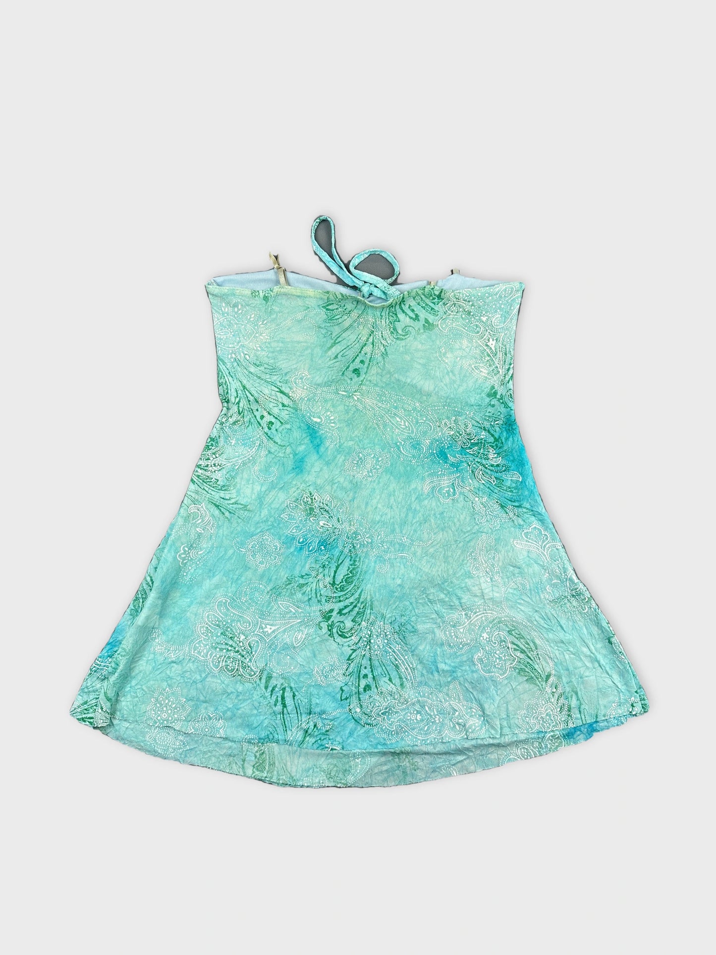 Back view of a turquoise women’s top with paisley pattern.