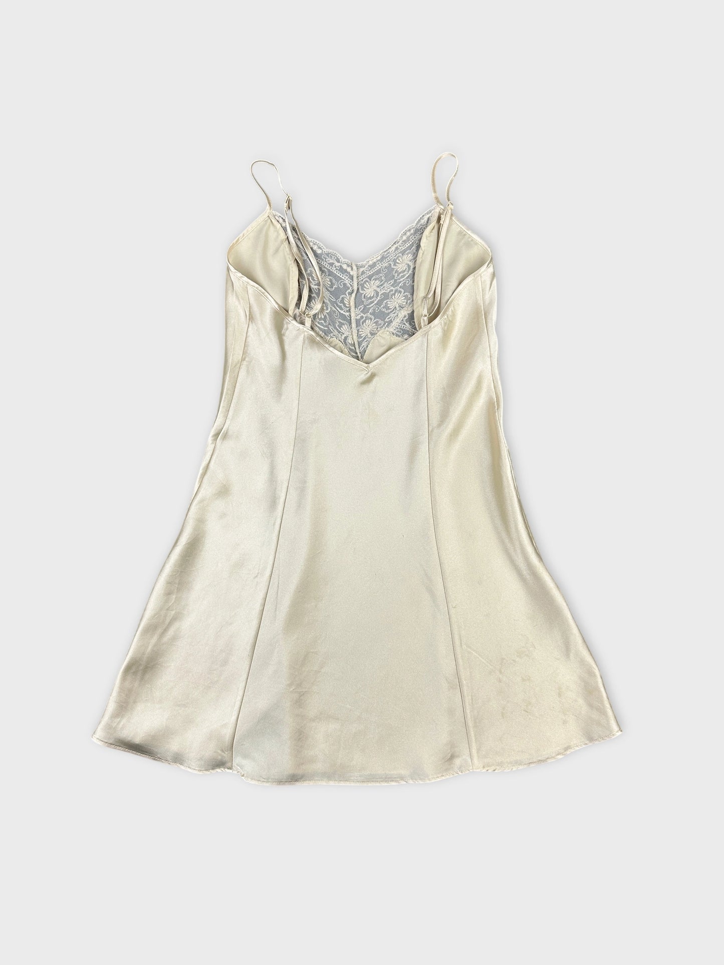 Back view of a vintage cream satin top with lace detail.