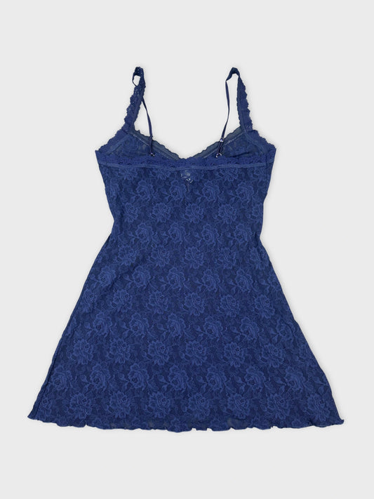 Back view of a women's navy lace top featuring floral pattern and adjustable straps.