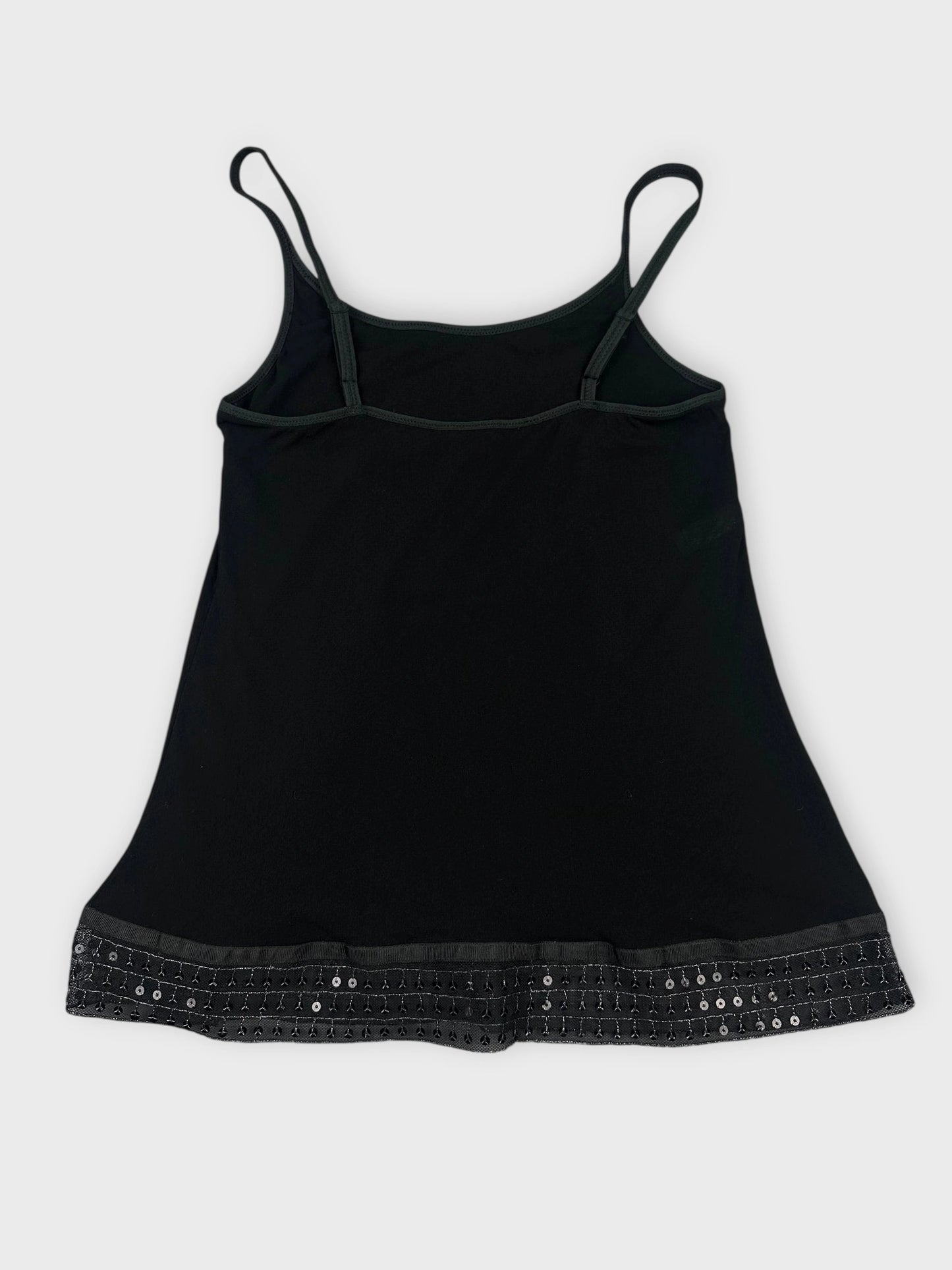 Back view of a black women's top with decorative sequined trim.