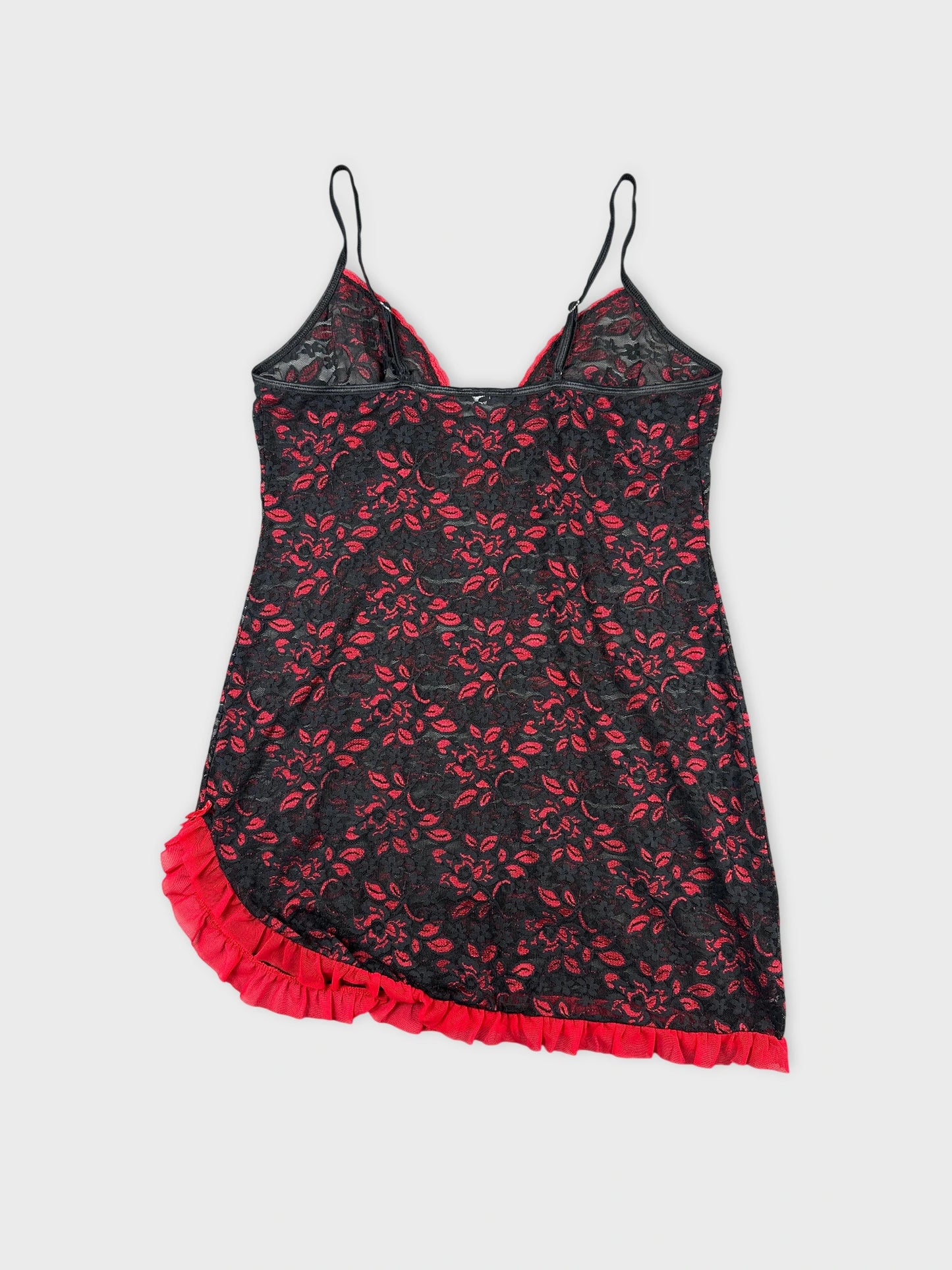 Back view of a black lace top with red floral pattern and ruffled hem.
