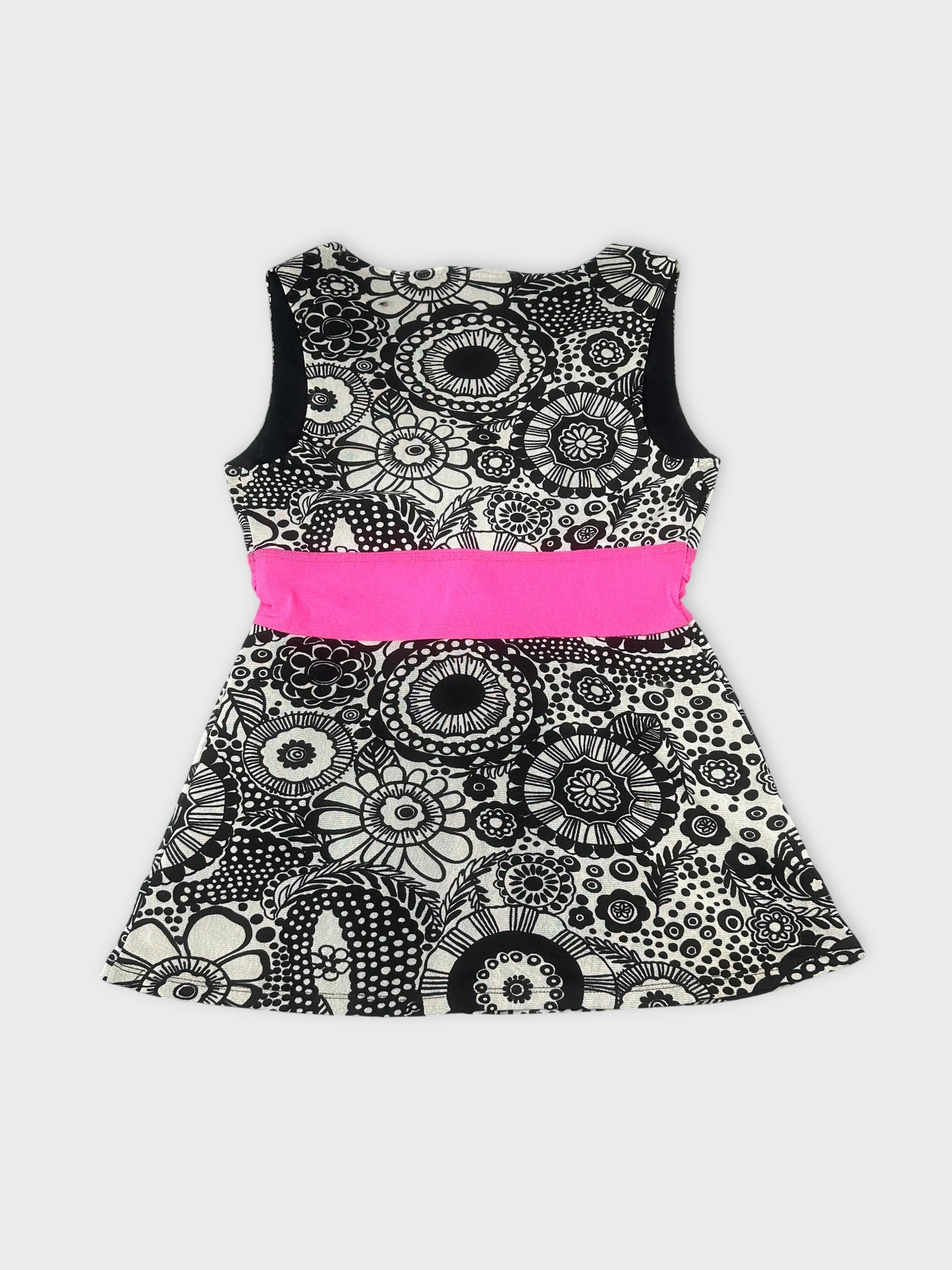 Back view of a sleeveless black and white floral dress with pink trim.