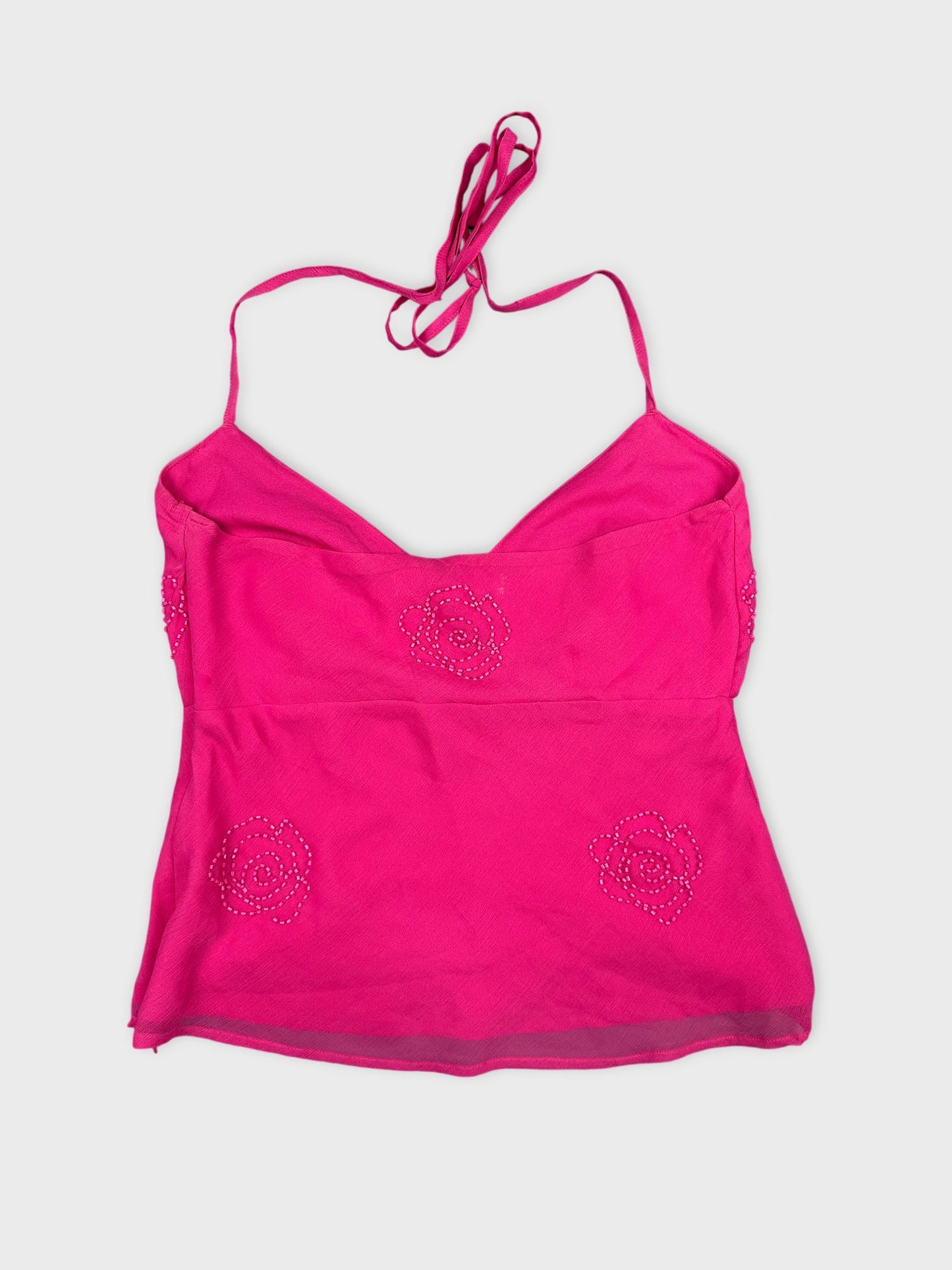 Back view of a pink women’s top featuring floral bead details.