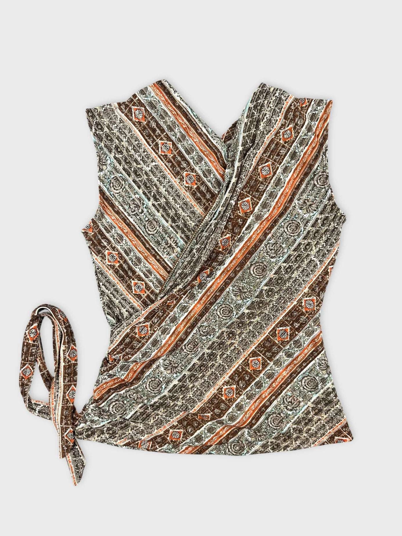 Back view of a women's wrap top in brown with geometric pattern and tie detail.