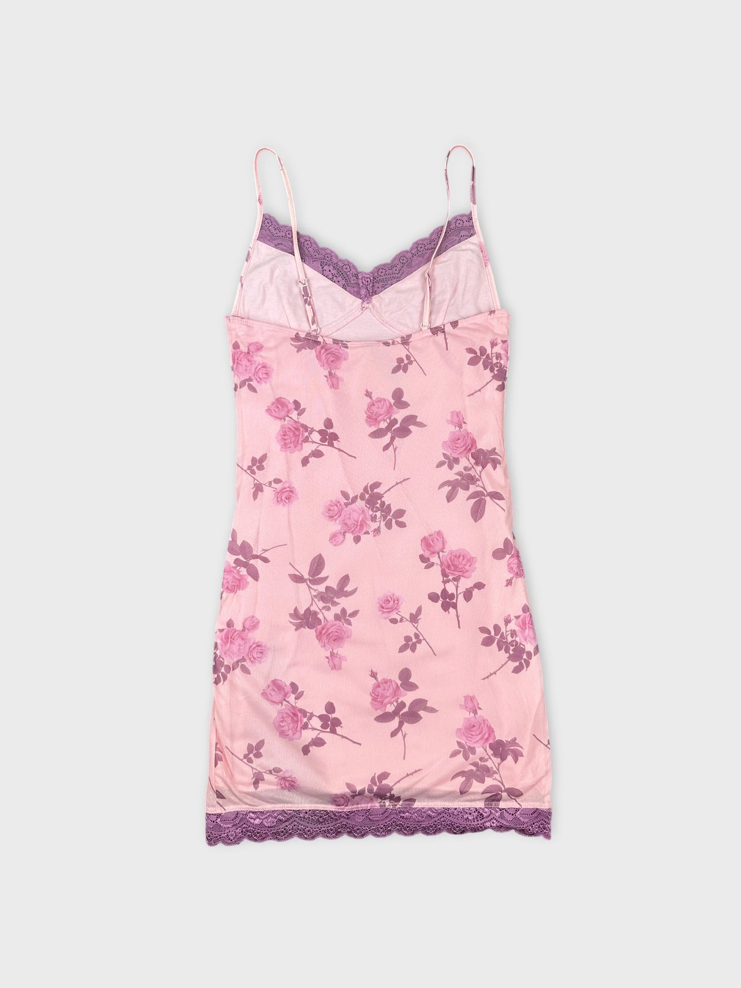 Back view of a pink floral camisole with lace trim.