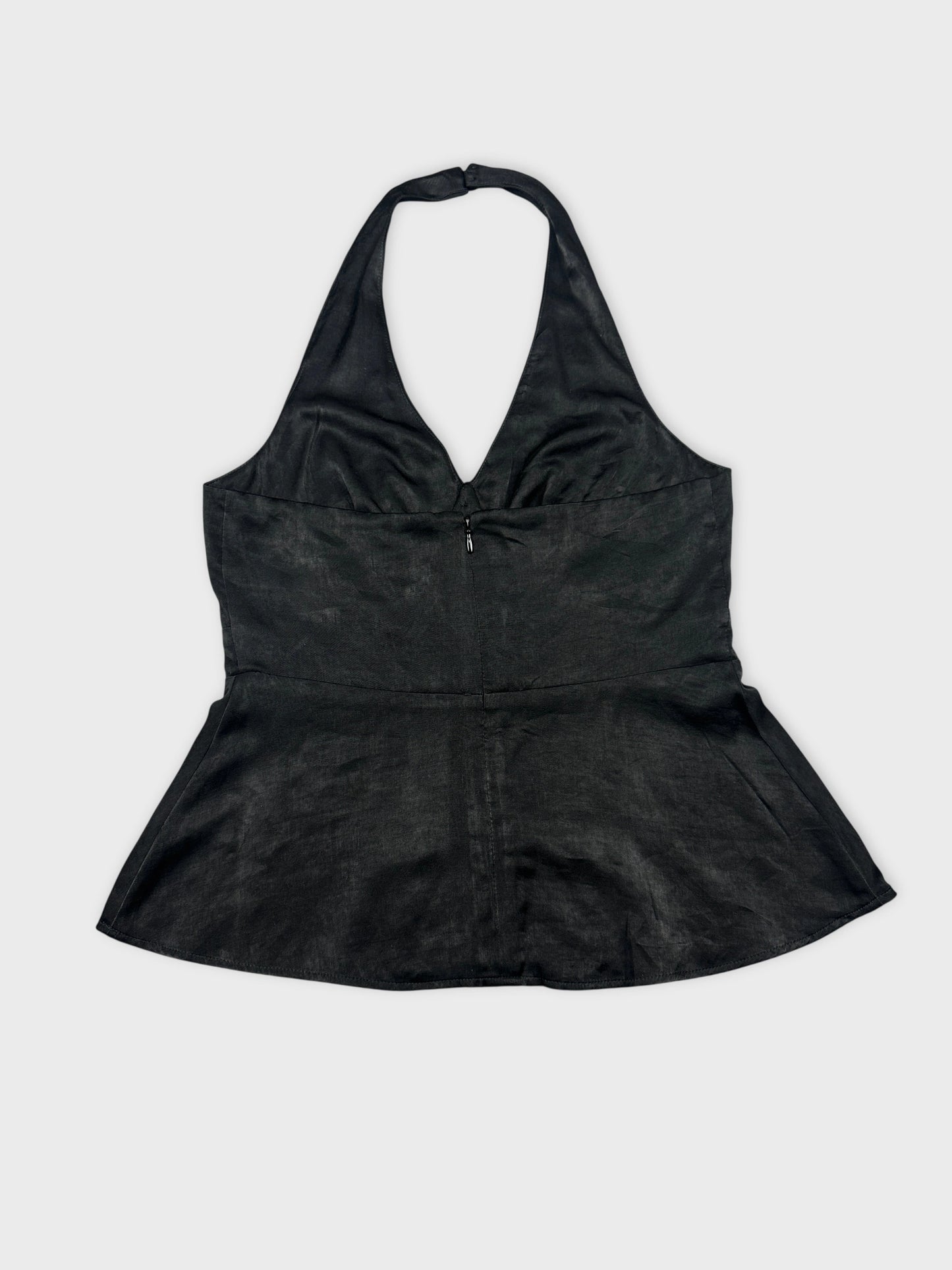 Back view of a black halter top with a fitted peplum shape.