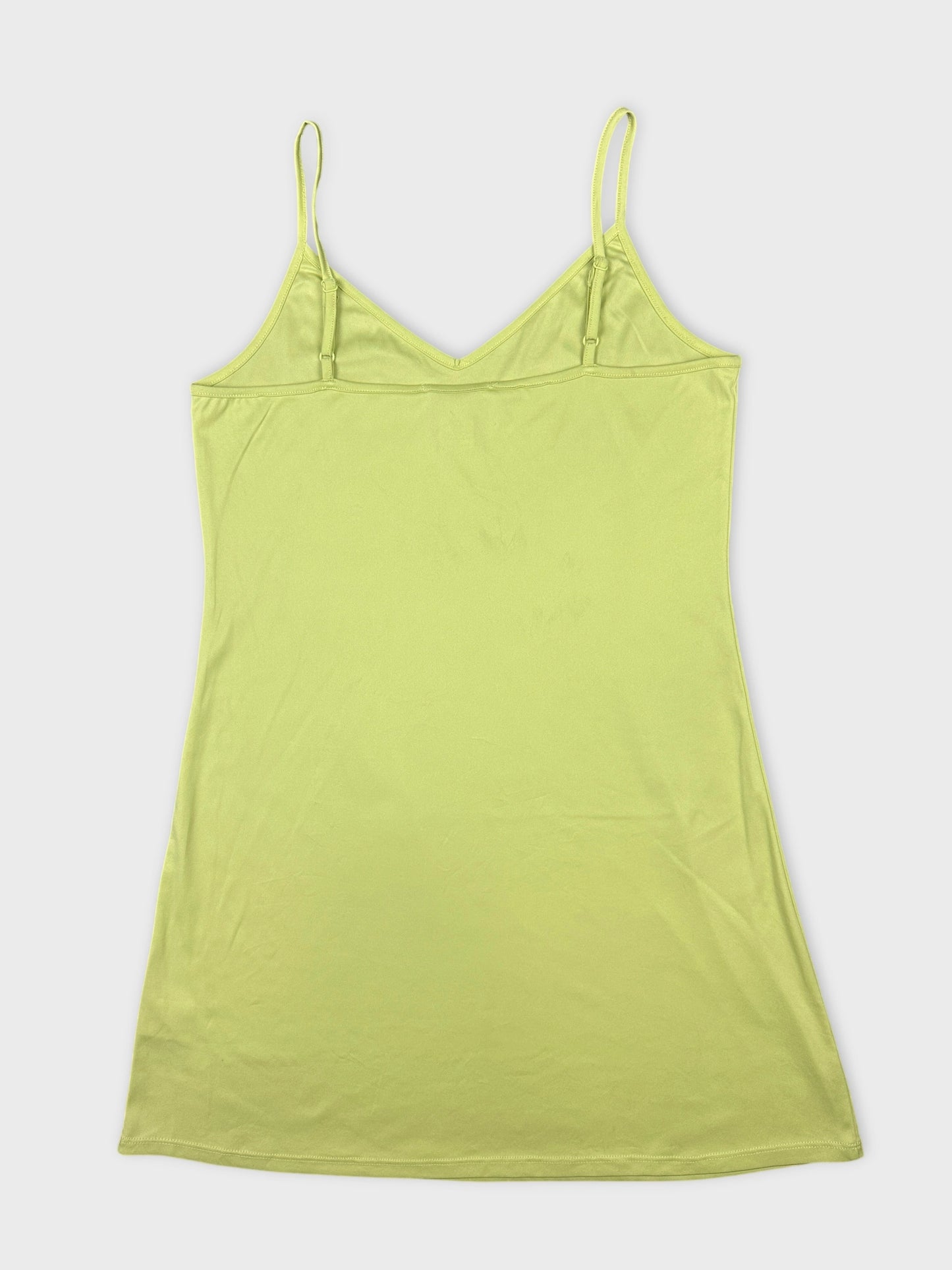 Back view of a lime green upper body top with thin spaghetti straps.