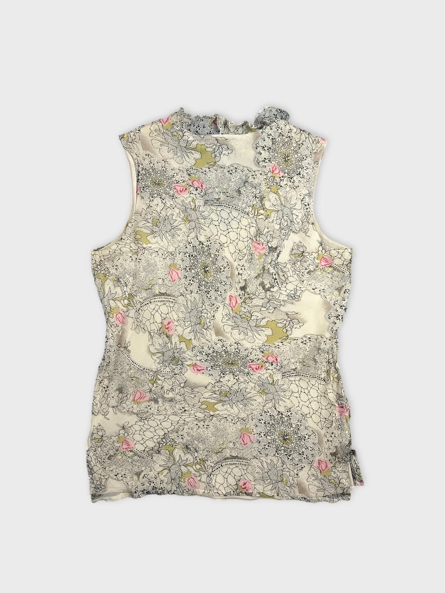 Back view of a sleeveless vintage top in cream with floral print.