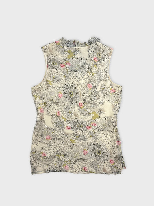 Back view of a sleeveless vintage top in cream with floral print.