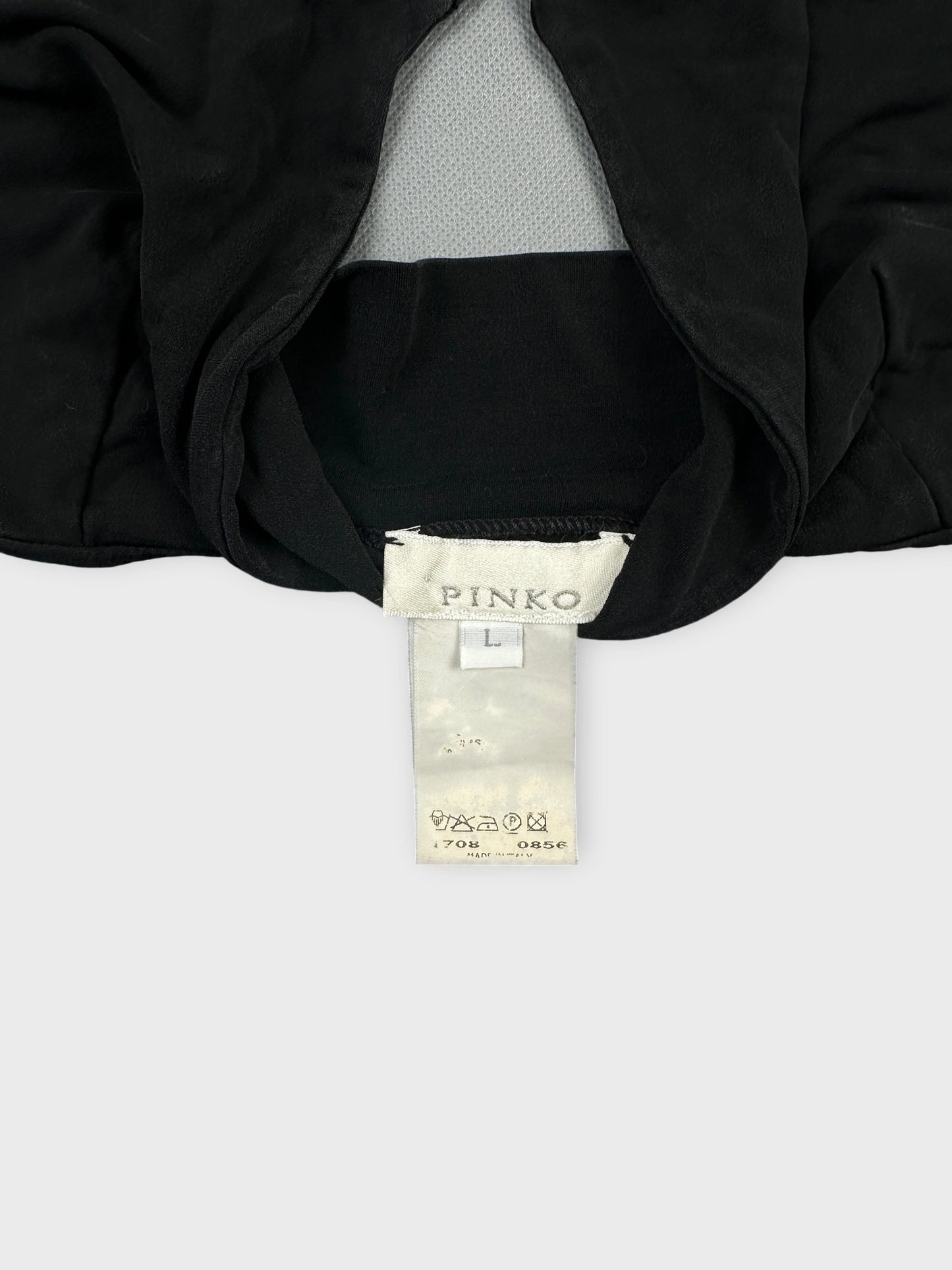 Detail view of a black upper body top featuring a mesh panel.