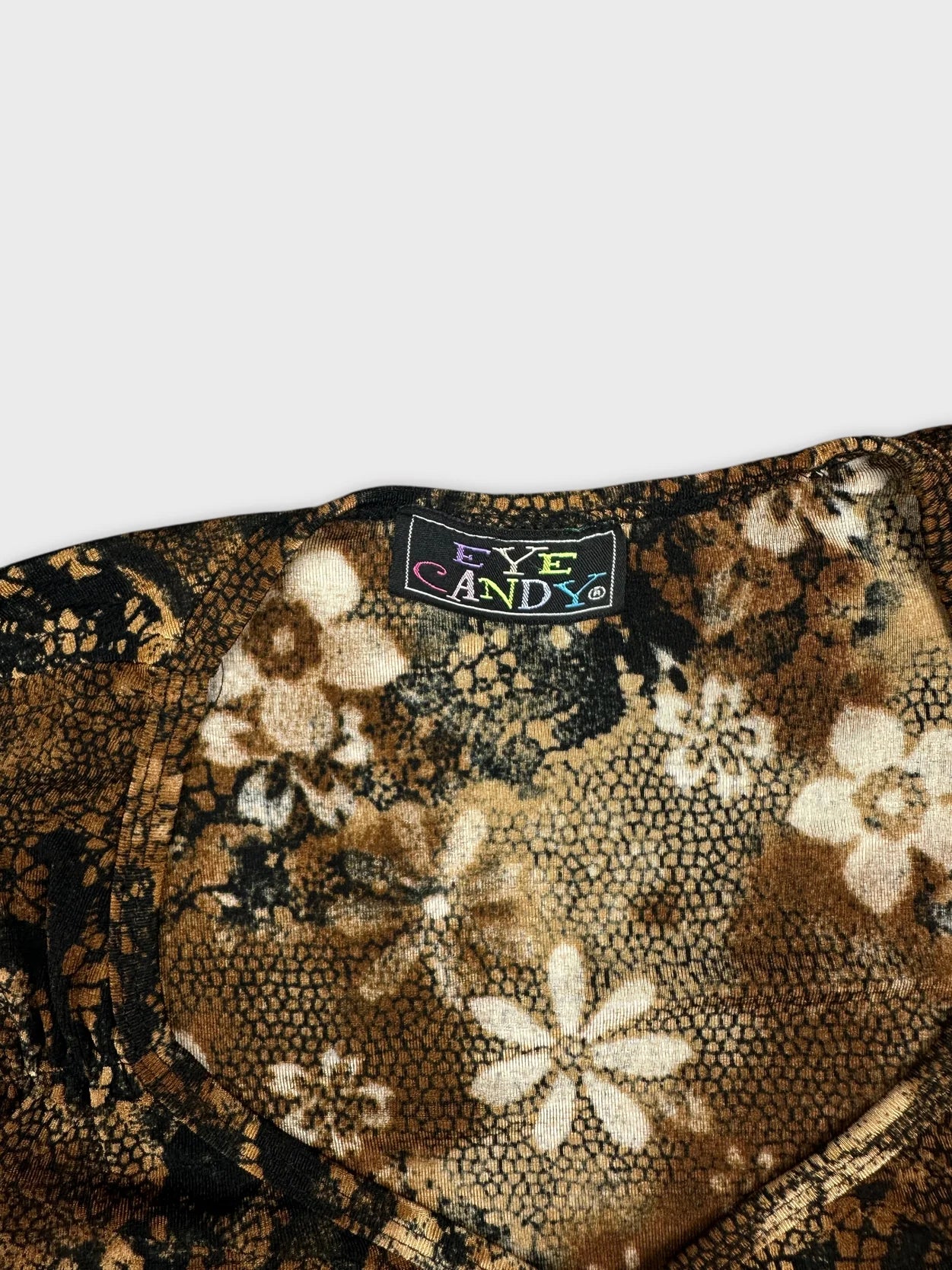 Detail view of a vintage floral print top in brown and black.
