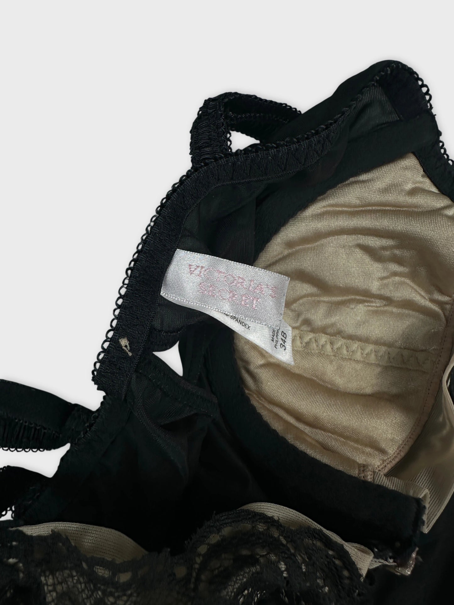 Detail view of a black women’s upper body top with lace trim.