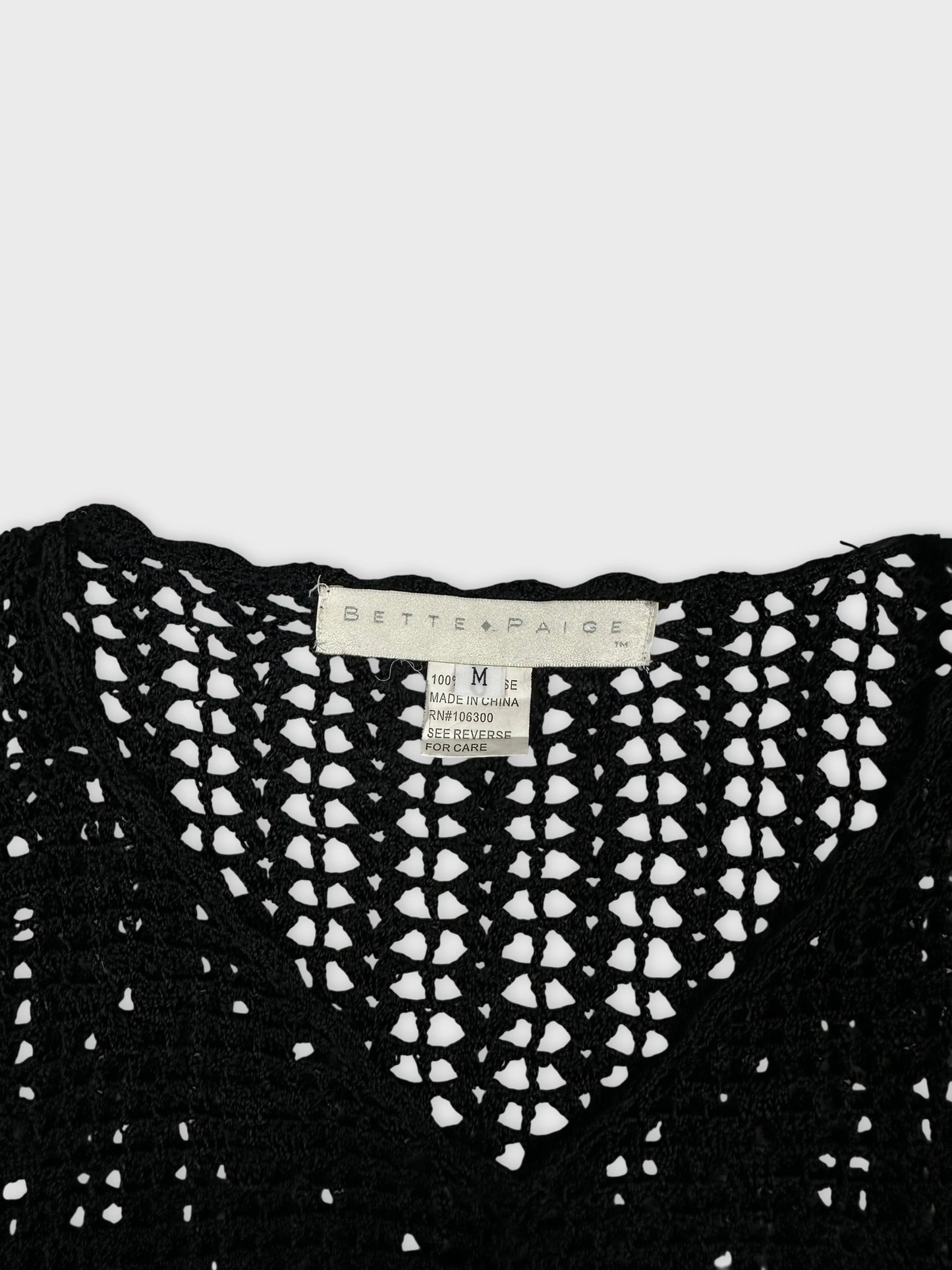 Black crochet top detail view with a v-neck design.