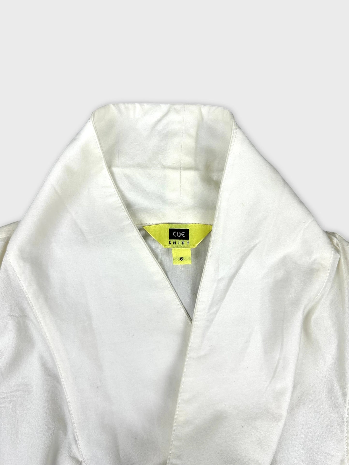 Detail view of a white vintage women's shirt neckline with a v collar.