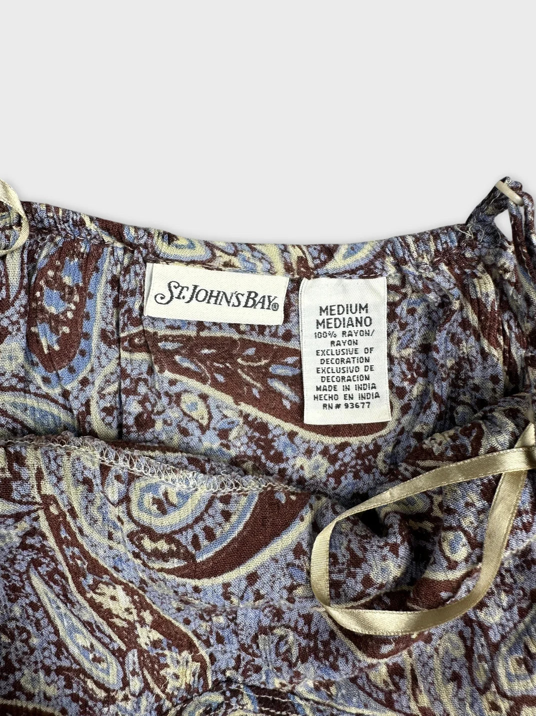 Detail view of a vintage upper body top in brown with paisley print.