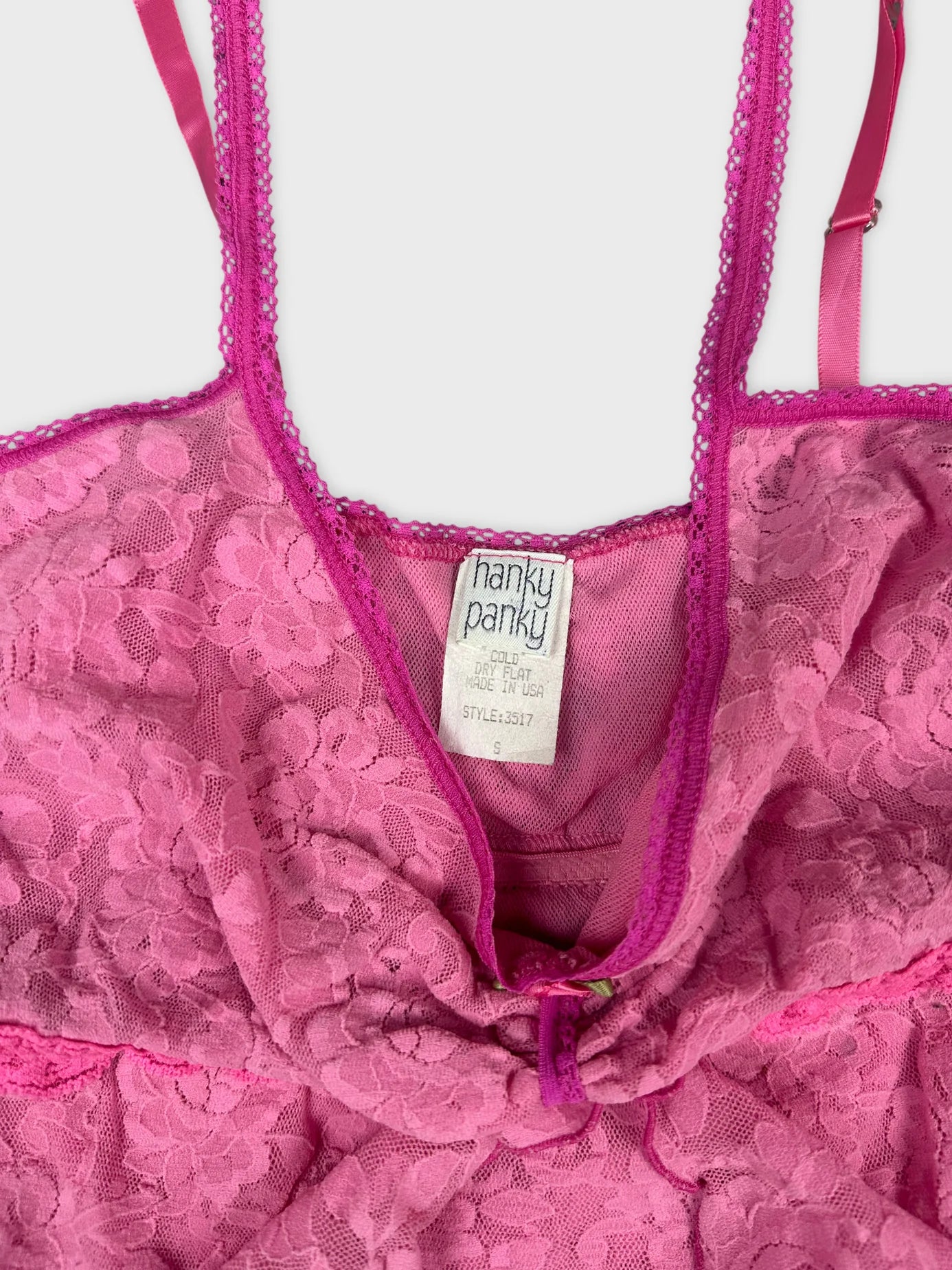detail view of a pink lace women's top with adjustable straps