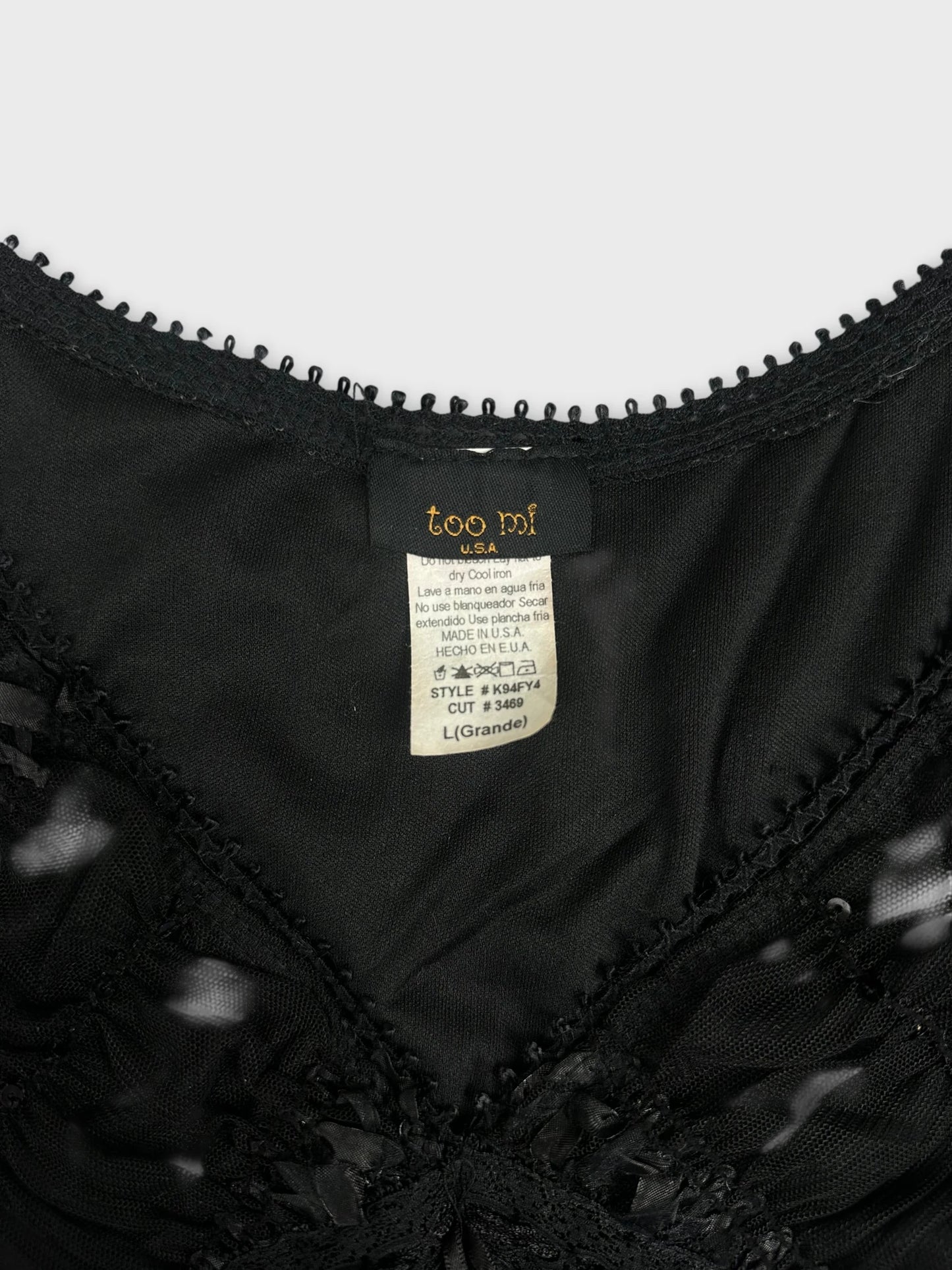 Black upper body top with lace trim detail view.