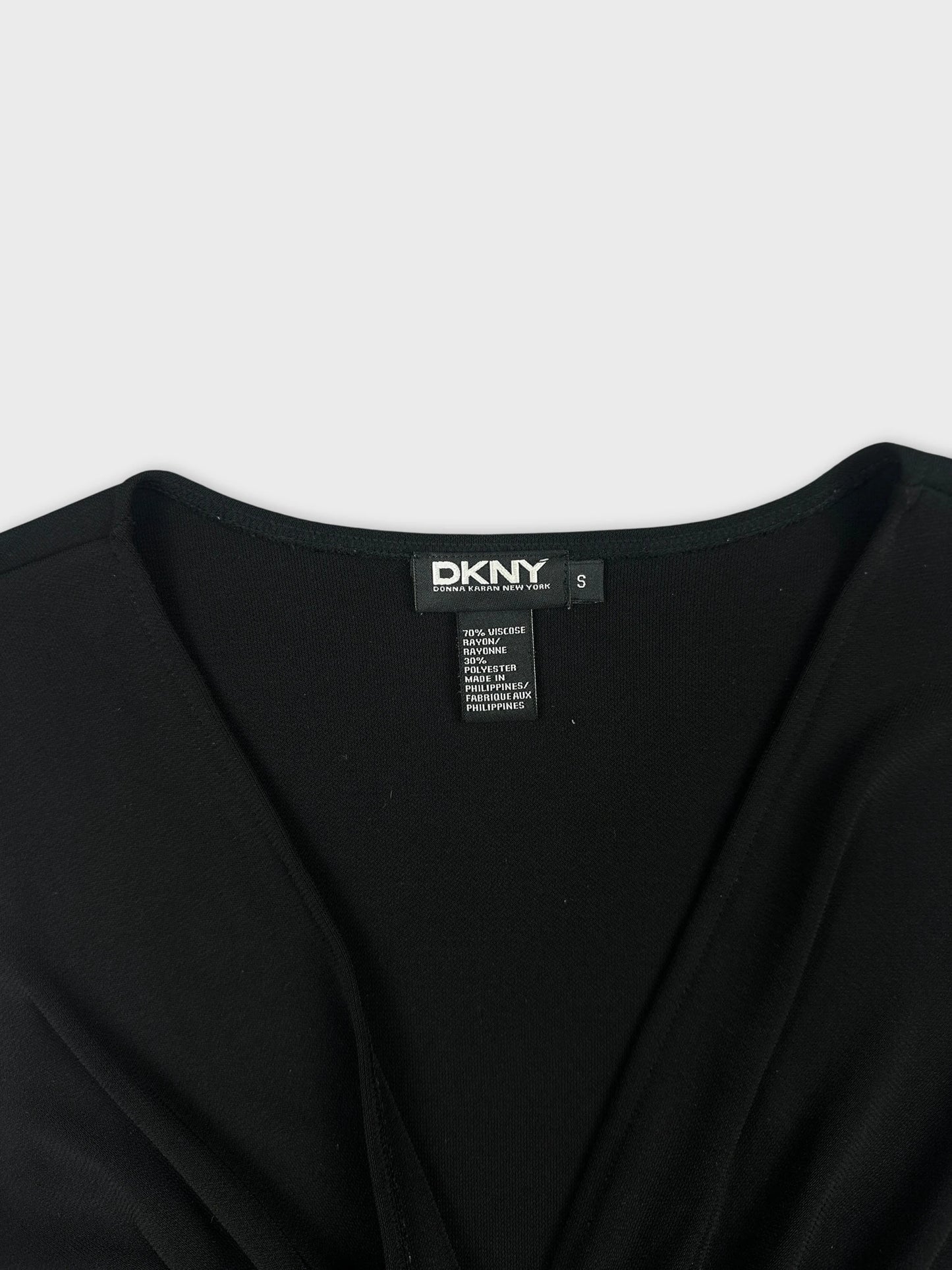 Detail view of a black women's top with a v-neck design.