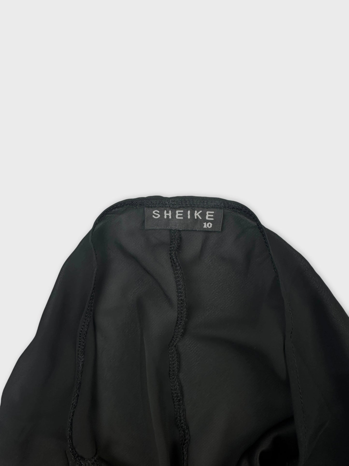 Detail view of a black women's top with visible stitching.
