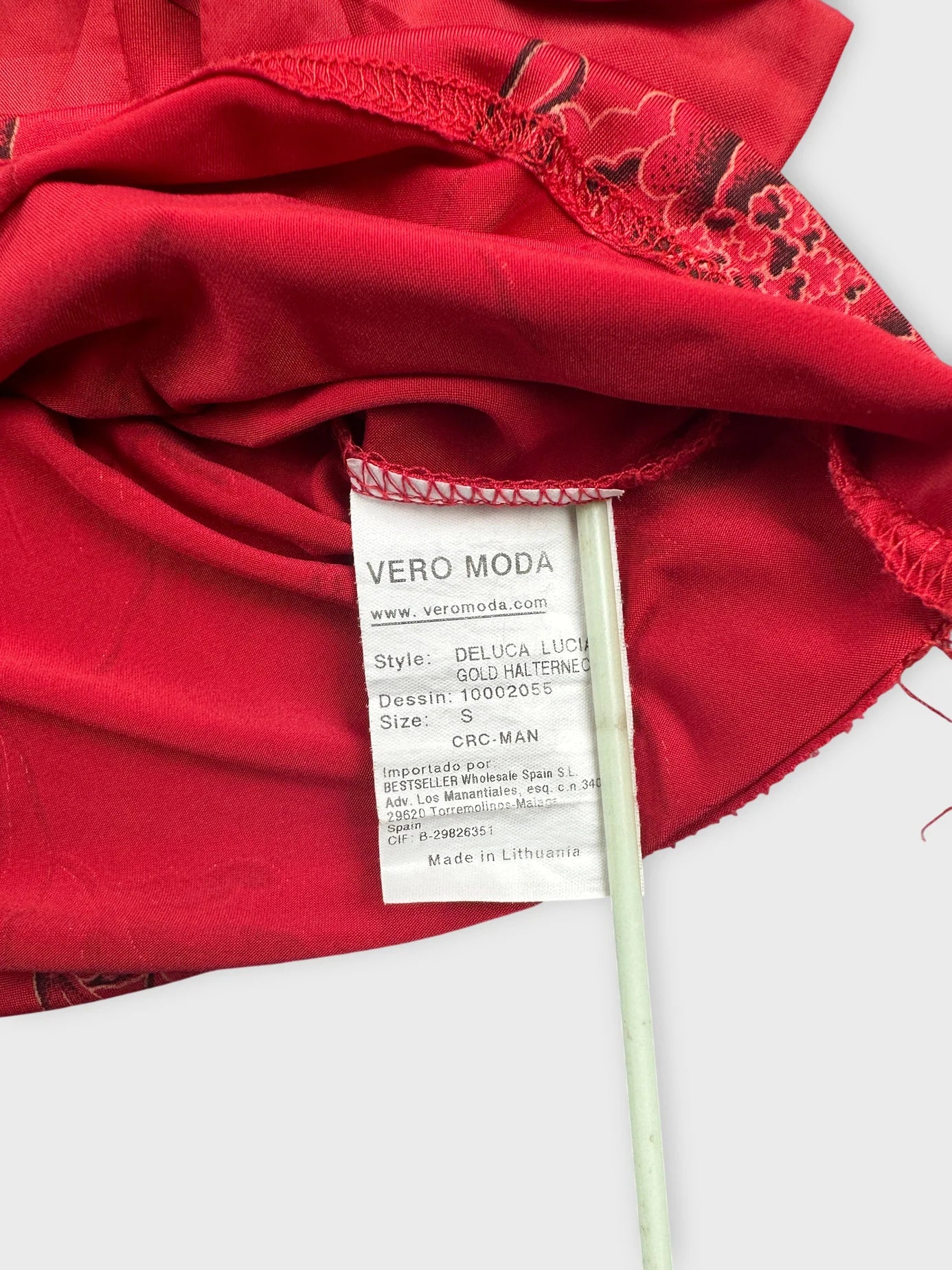 Detail view of a red vintage upper body top featuring floral print.