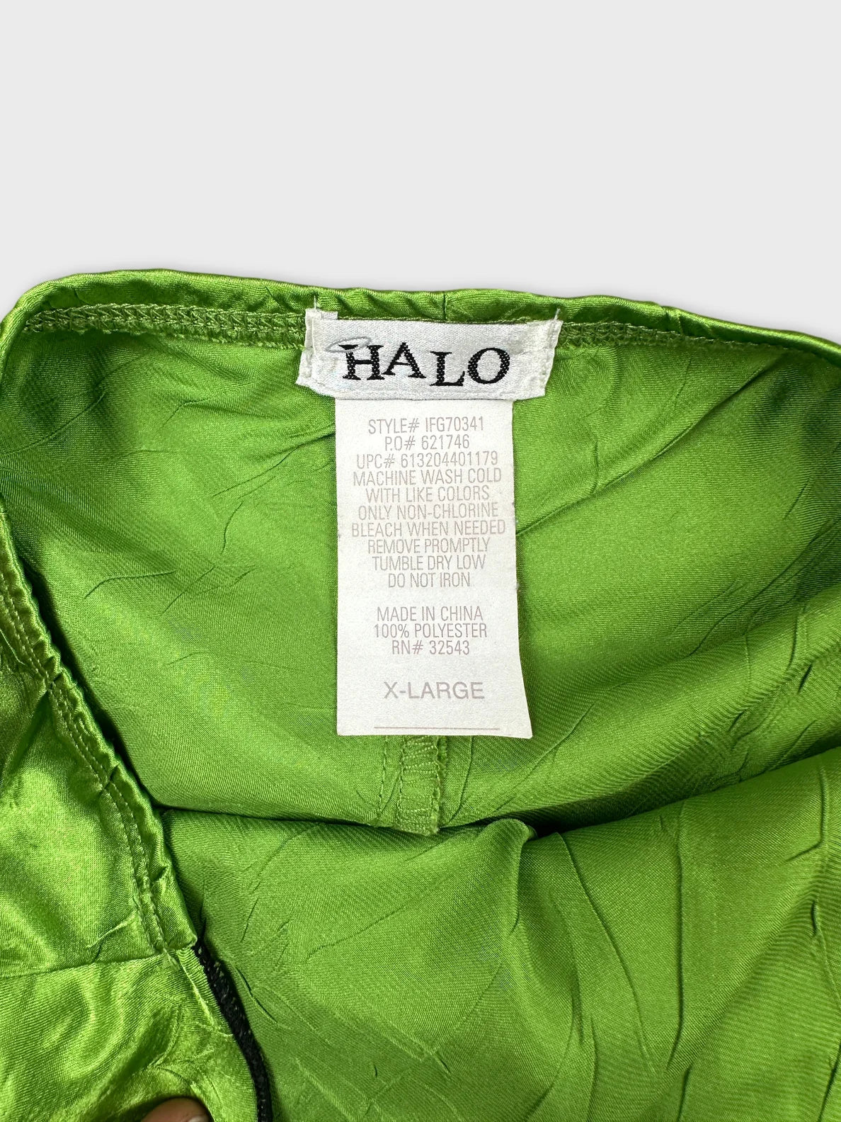 Green upper body top detail view featuring a smooth satin texture.