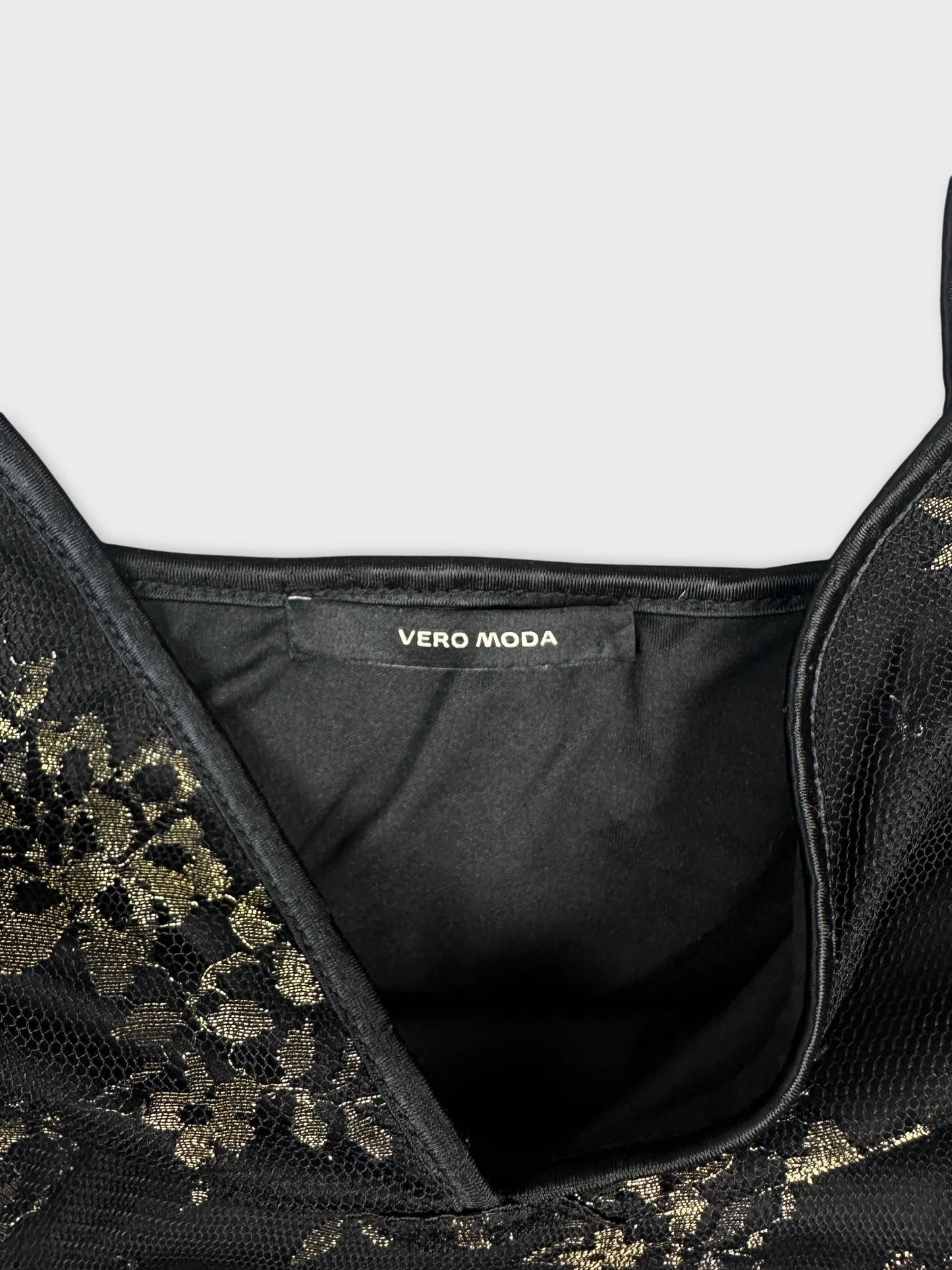 Detail view of a black floral patterned top with a V-neck.