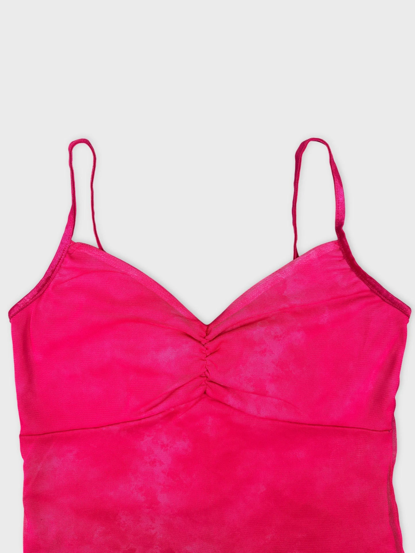 Detail view of a pink tie-dye women's top with thin straps.