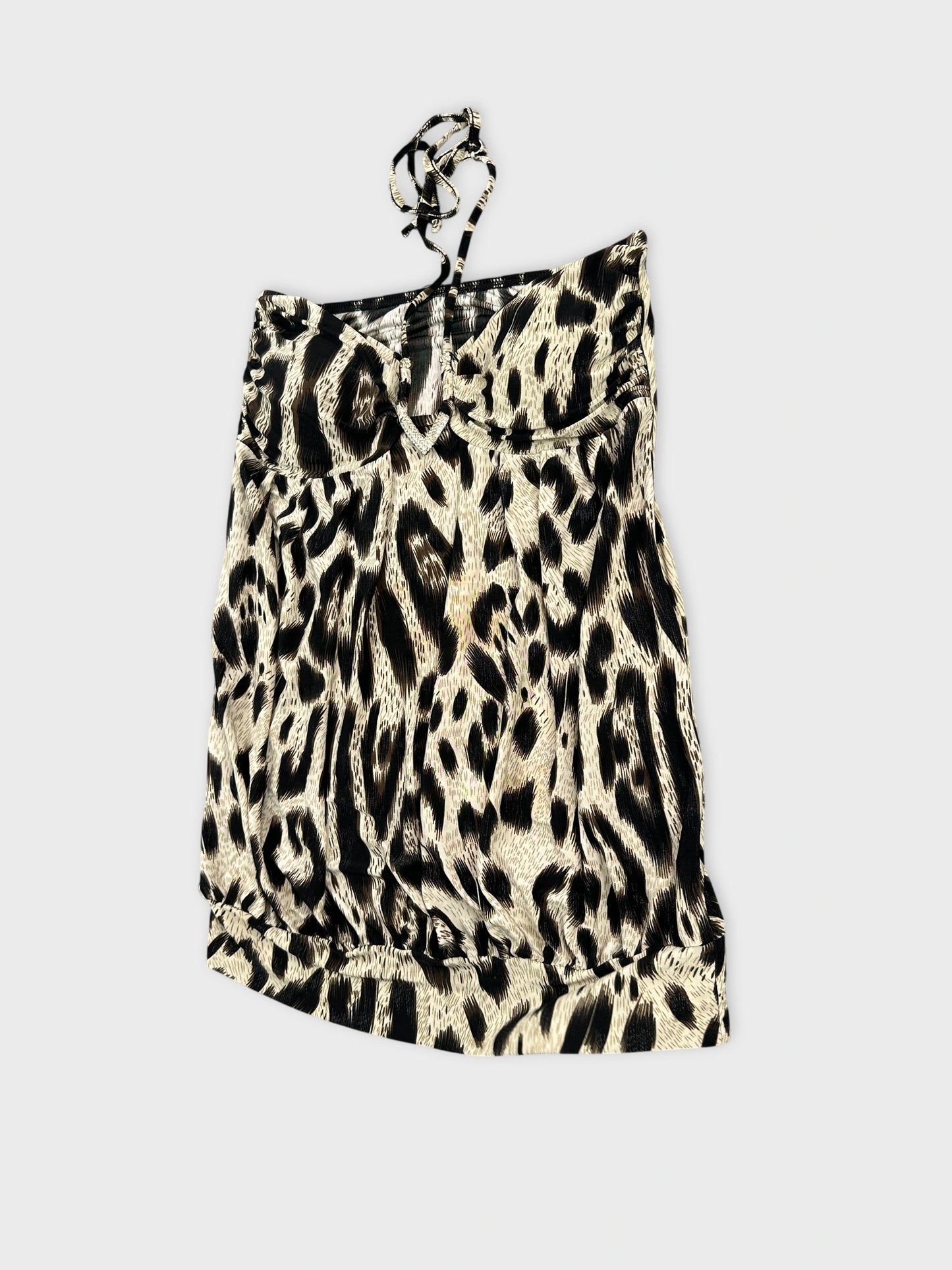 Detail view of a women's leopard print top in beige and black.