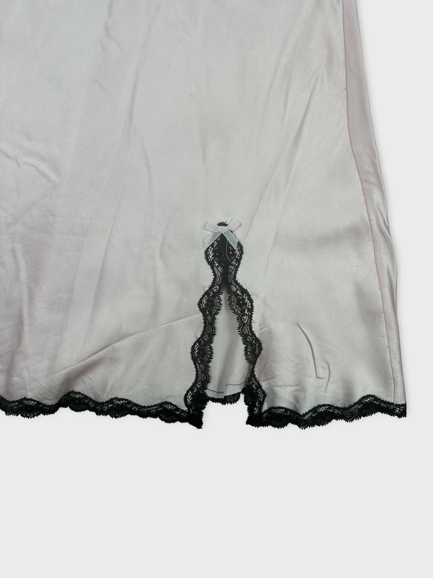 Silky pink upper body top with black lace detail view.