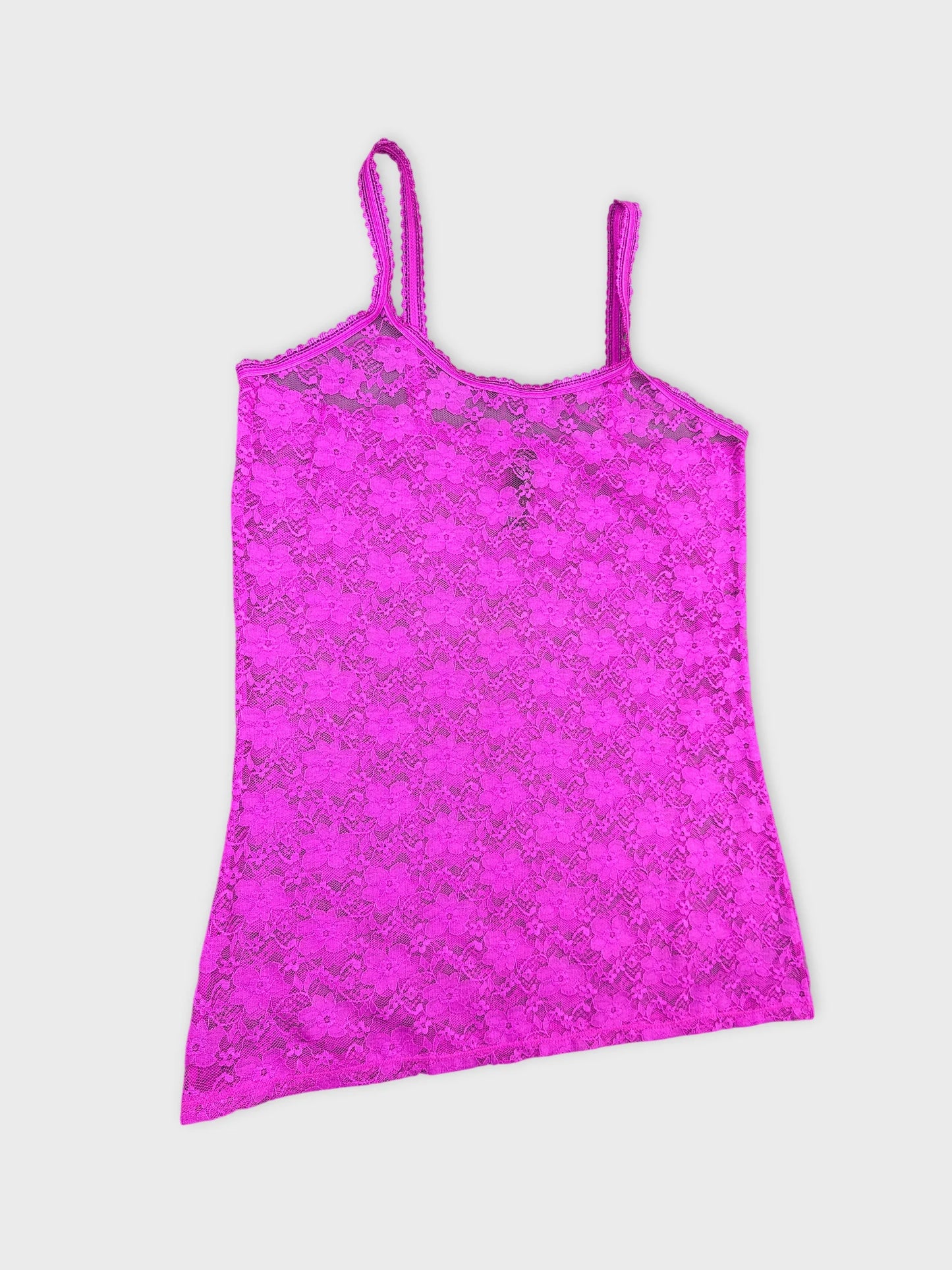 Detail view of a pink lace camisole with spaghetti straps.
