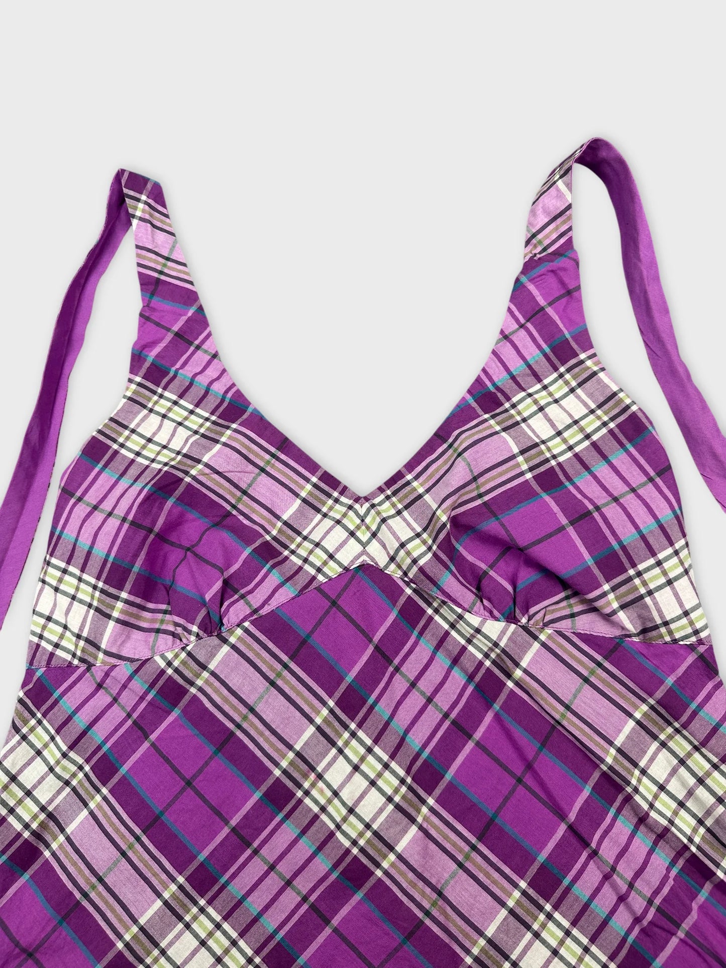 Detail view of a purple plaid women's top with adjustable straps.