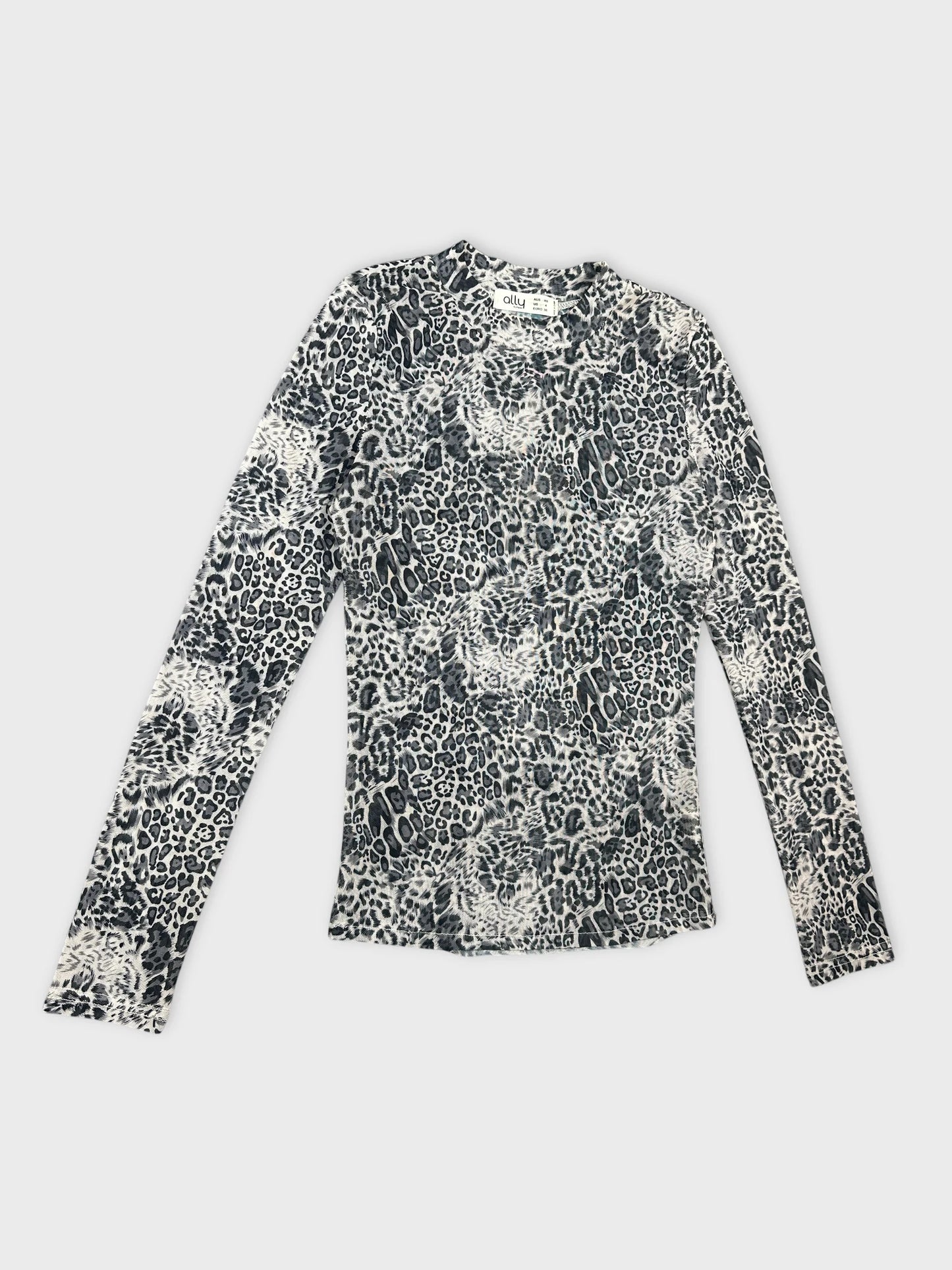 Detail view of a long-sleeve top in black and white leopard print.