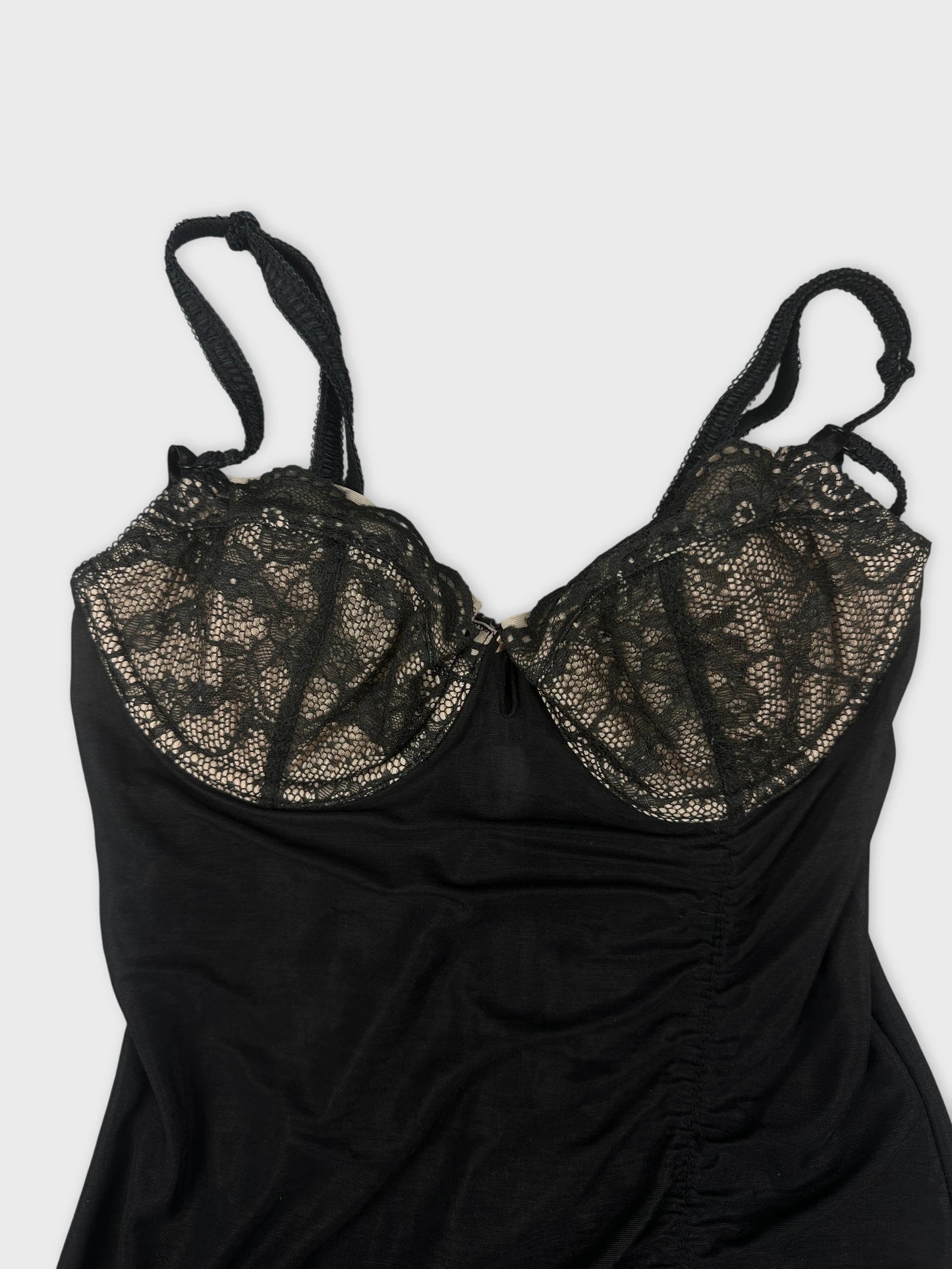 Black top with lace detailing in a detail view