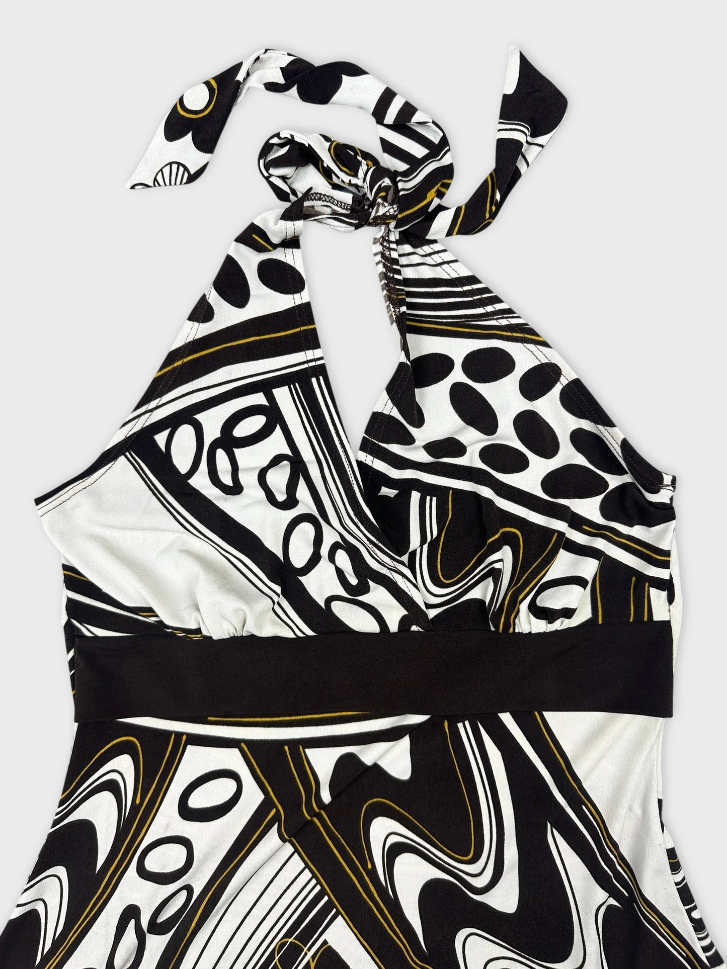 Detail view of a black and white patterned halter-top with a tied neckline