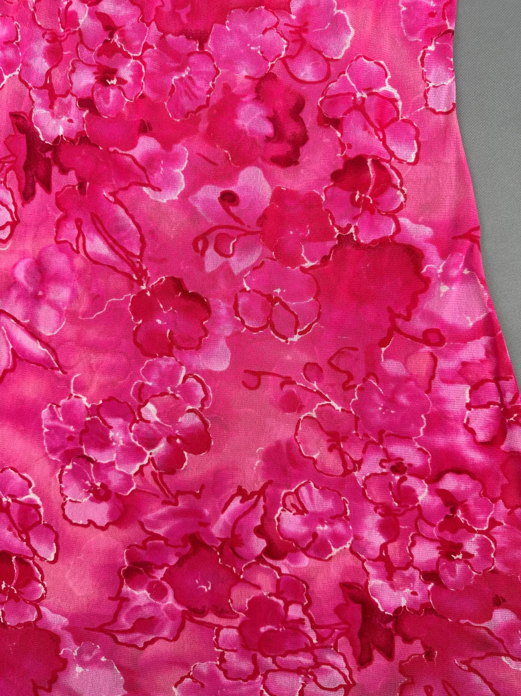 Detail view of a pink floral patterned vintage women’s top.