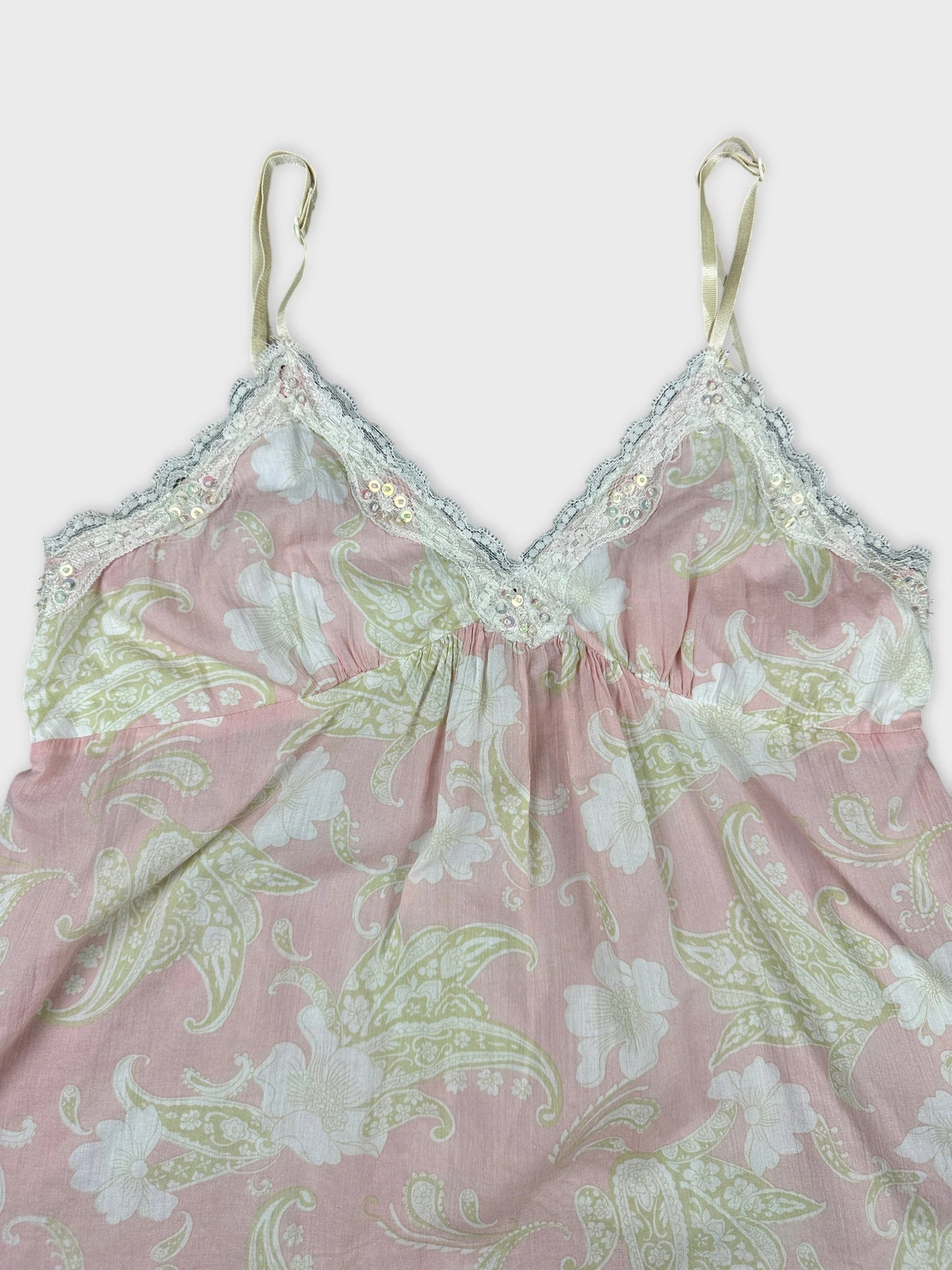Detail view of a pink floral camisole with lace trim.
