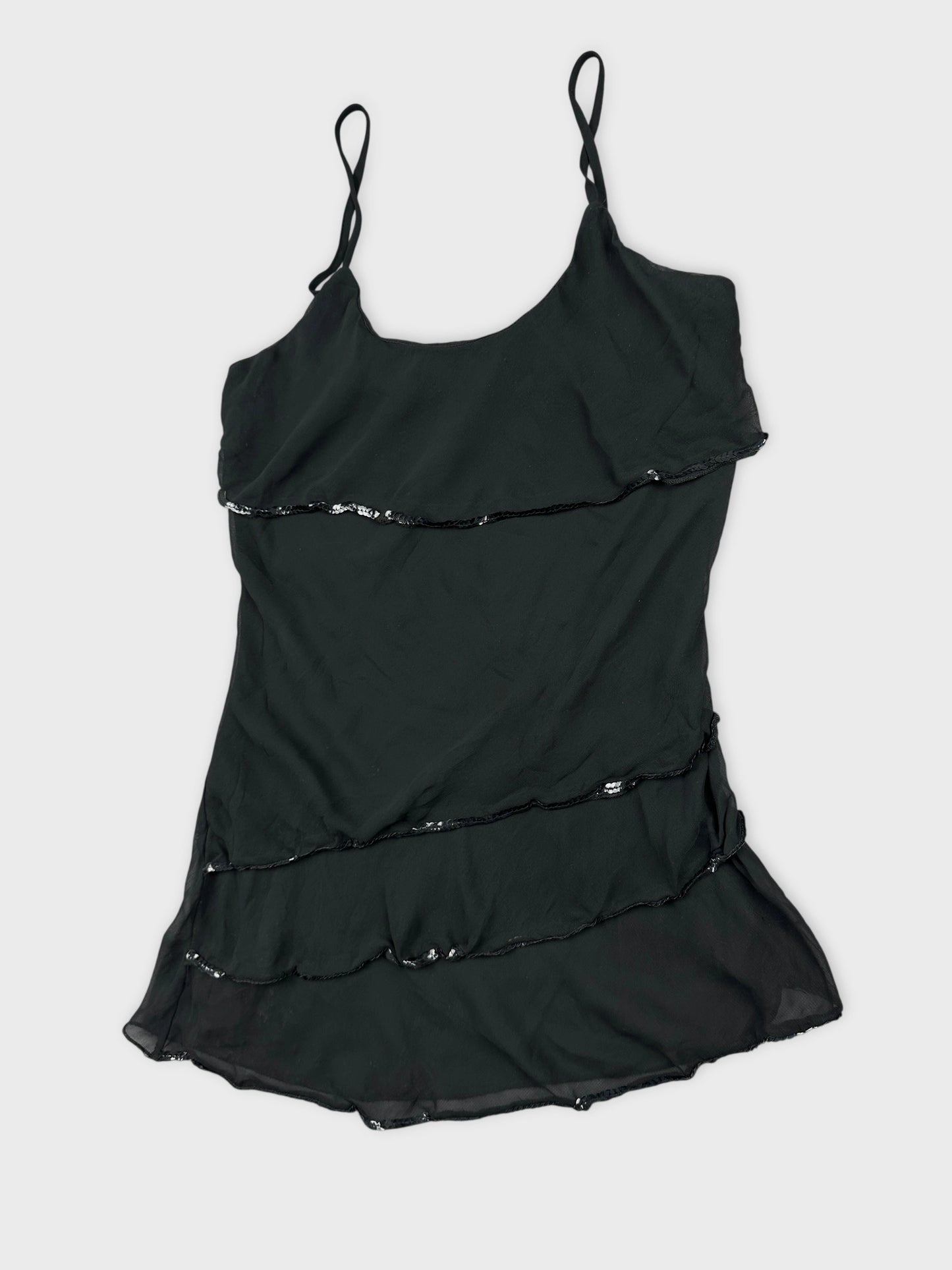 Detail view of a black layered top with sequin trim.